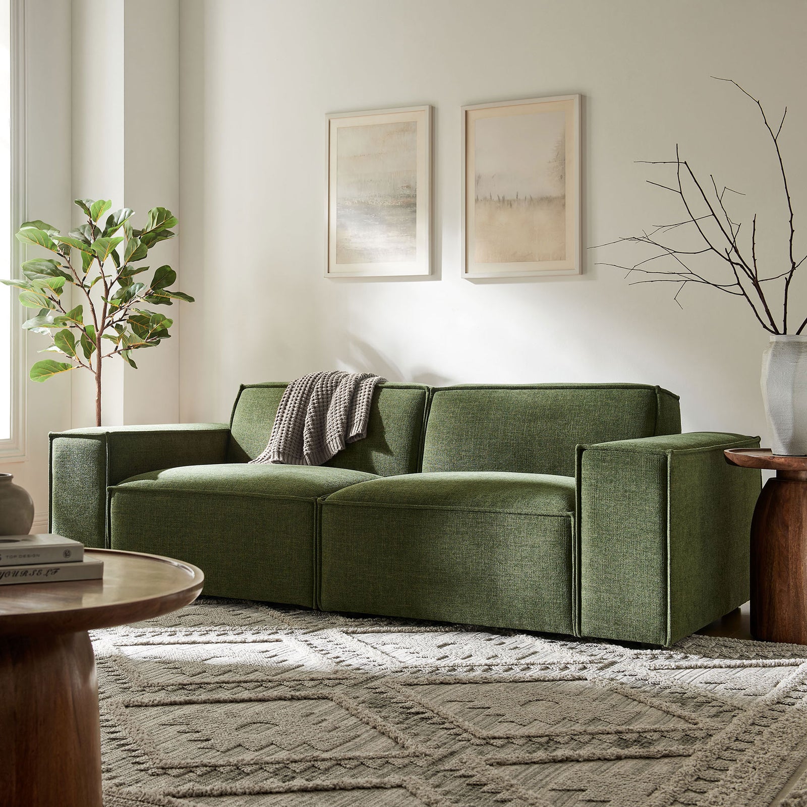Streamlined foliage green loveseat with plush cushions, framed art, and plants creating a calm lounge setting. || EEI-7403-FOL || front_room