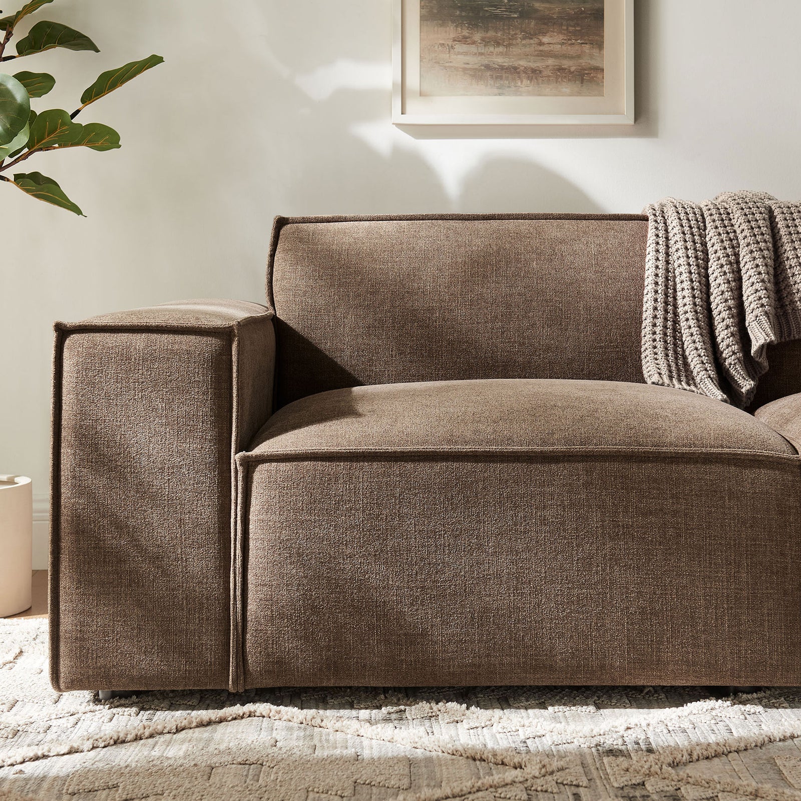 Cozy mocha upholstery with French piping and a chunky knit throw draped over the wide track arm || EEI-7403-MOC || detail_room