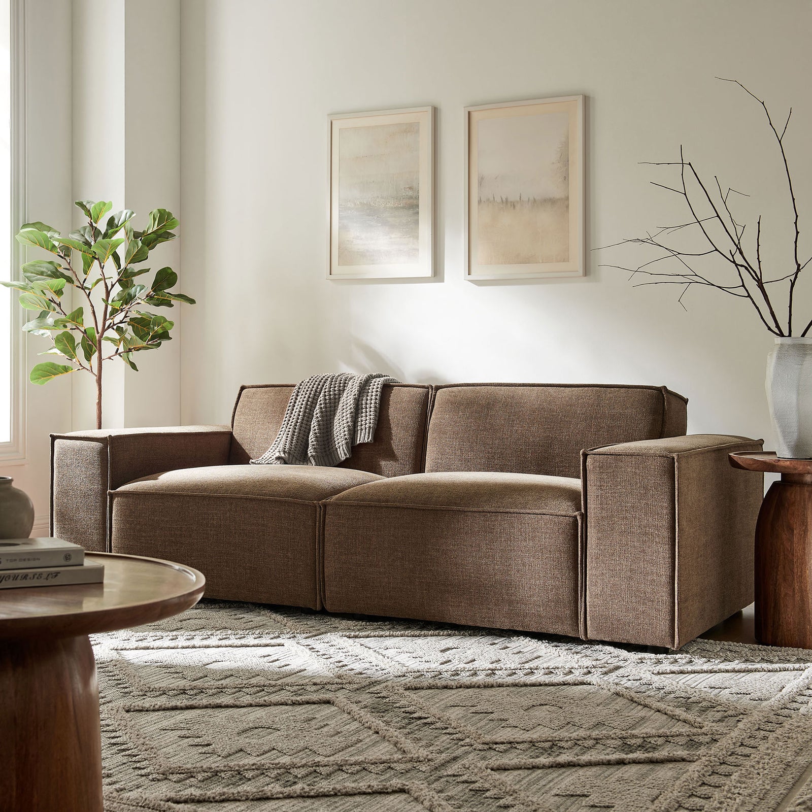 Inviting mocha performance loveseat anchored on a patterned rug with soft artwork and greenery in the background || EEI-7403-MOC || front_room
