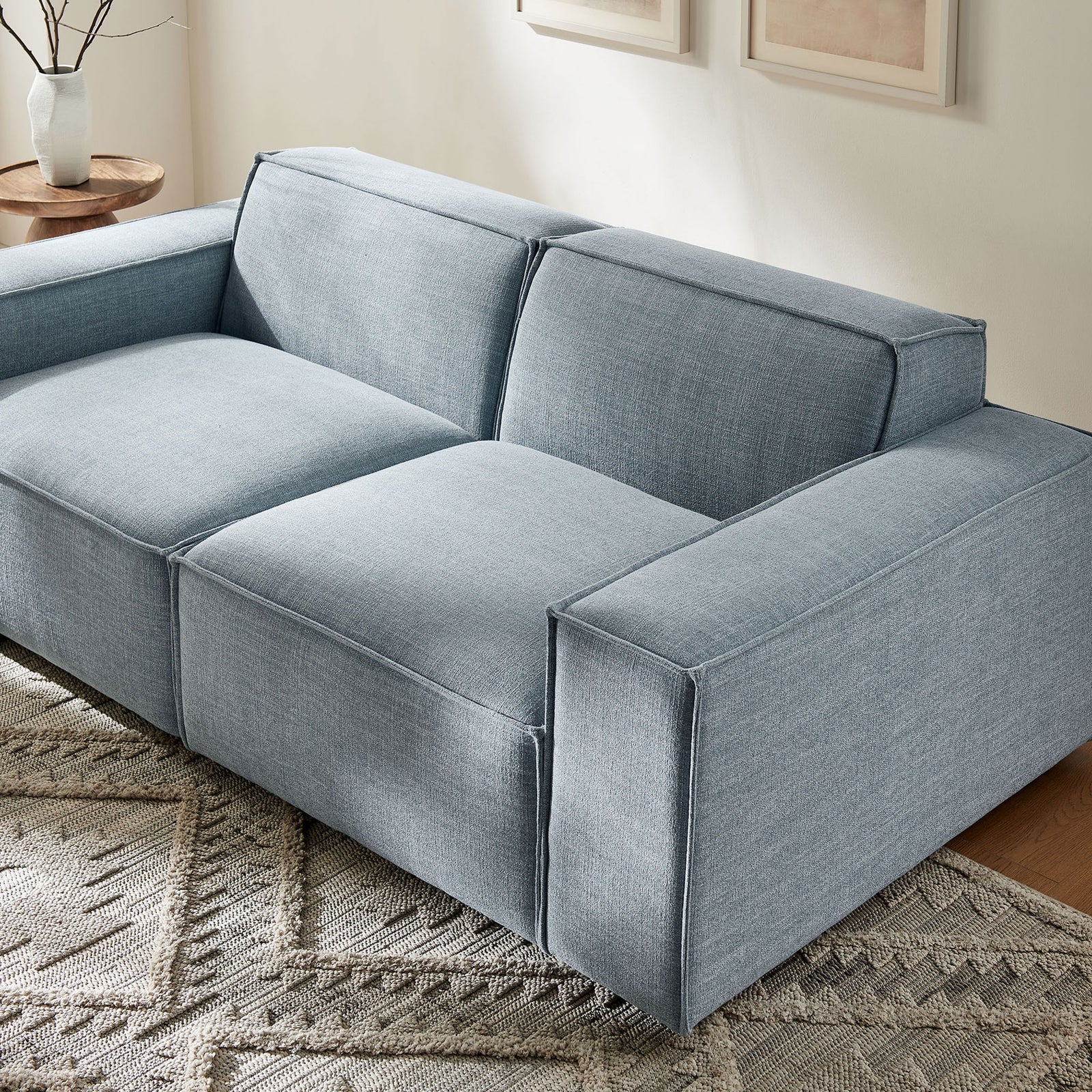 Sky blue modular loveseat anchoring a bright living room with neutral rug and artwork || EEI-7403-SKY || detail_room