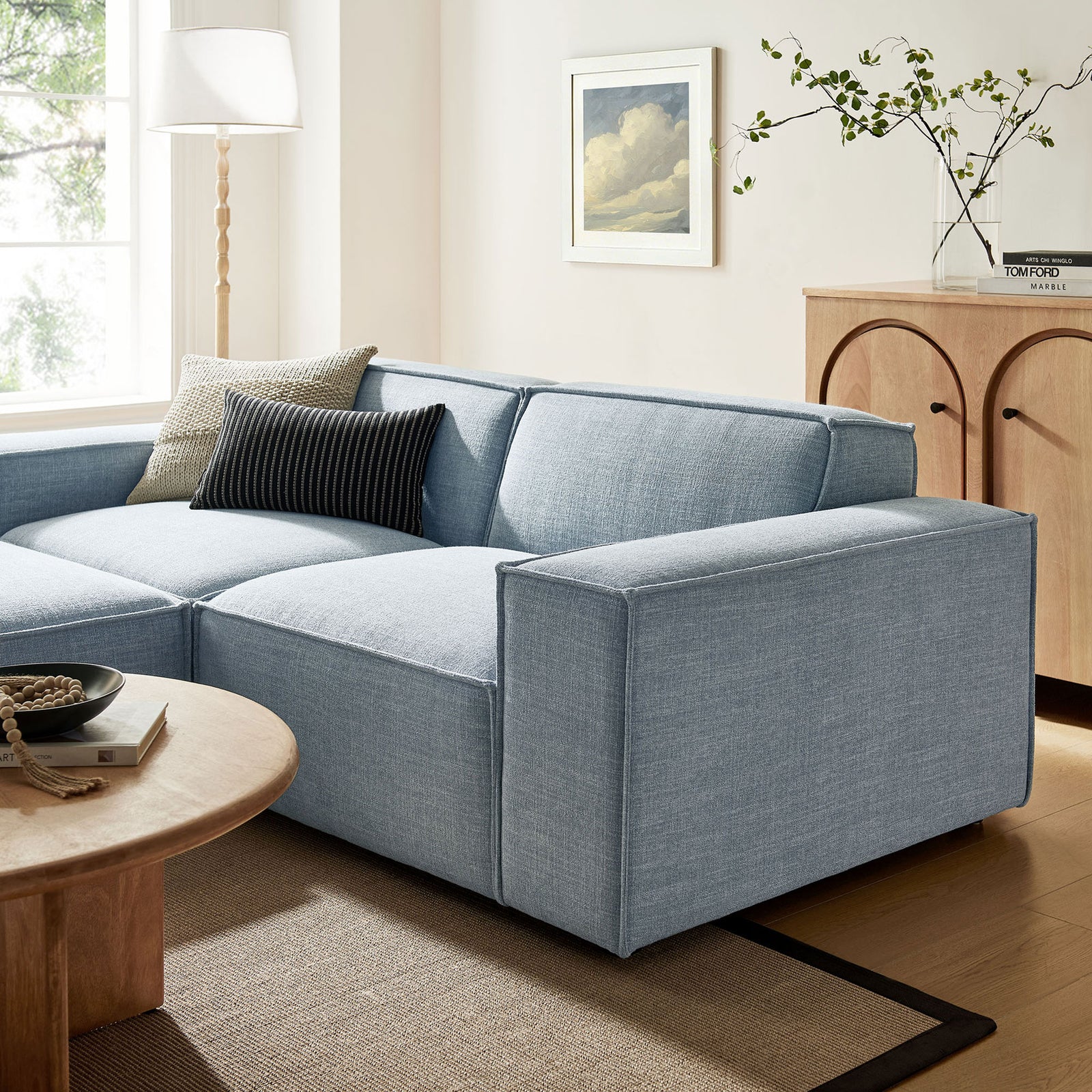 Sky blue Restore modular loveseat styled in a warm living room with layered pillows and natural wood decor || EEI-7405-SKY || detail_room