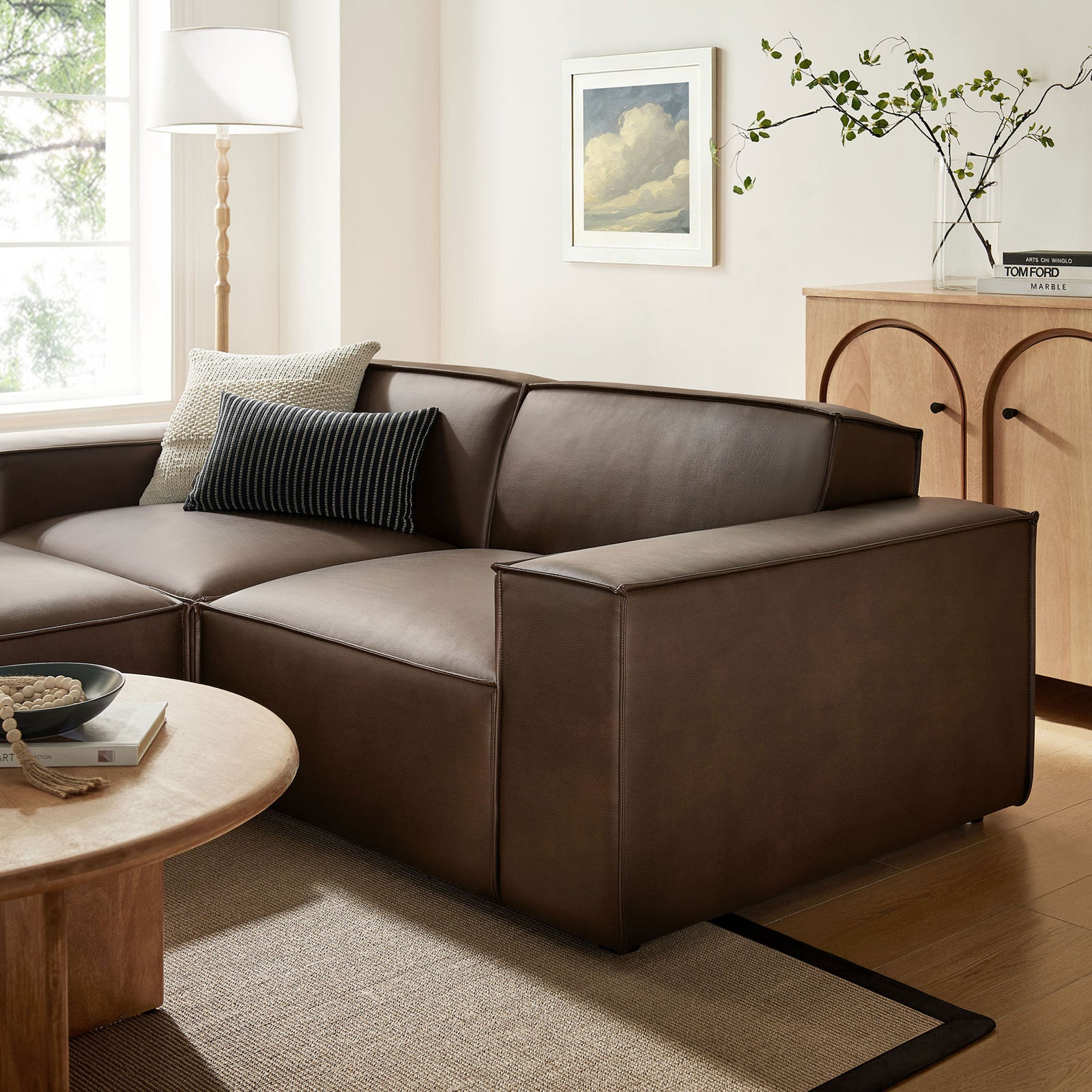 Broad espresso vegan leather arm and back cushions showcase tailored stitching and a soft, supportive seating feel. || EEI-7406-ESP || detail_room