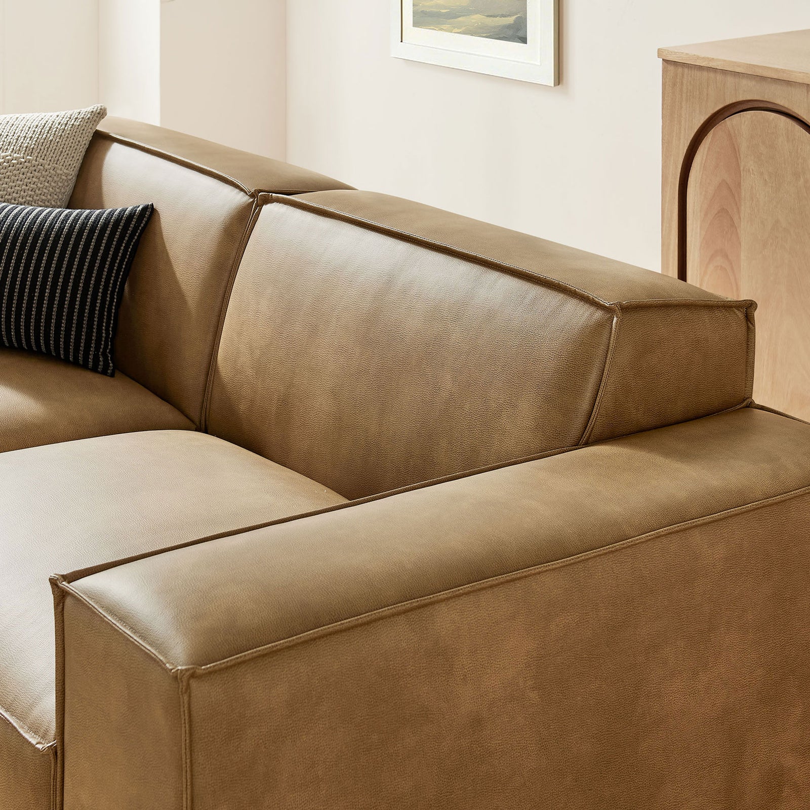 Detail of the Restore toast vegan leather loveseat arm showing tailored French piping and soft cushions || EEI-7406-TST || detail_room