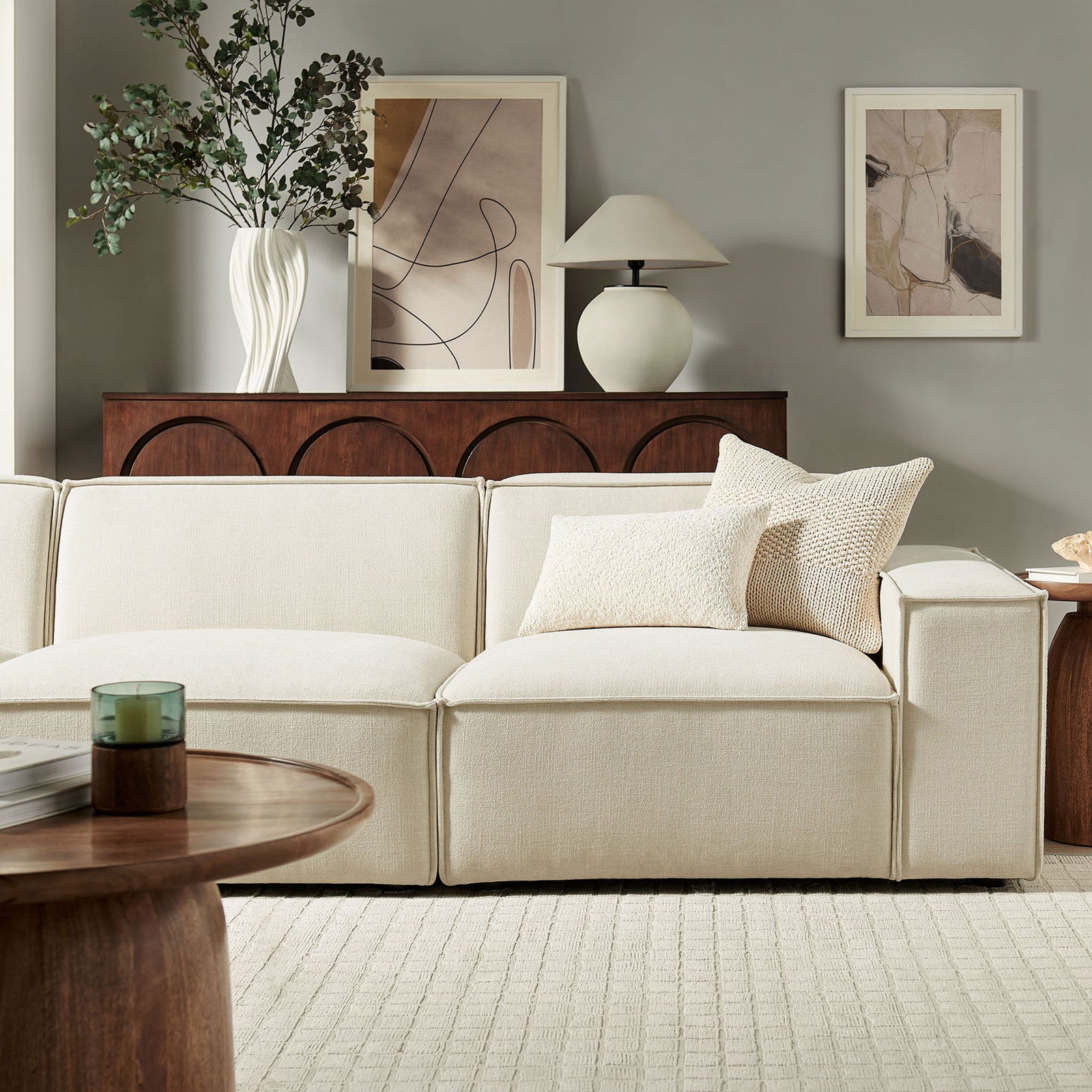 Ecru modular sofa corner styled with textured throw pillows for cozy modern living room comfort || EEI-7407-ECR || detail_room