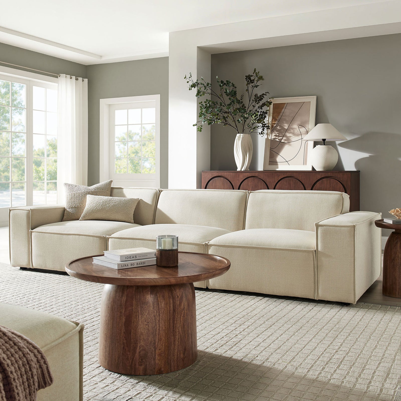 Ecru modular sofa styled in airy living room with warm wood accents and layered neutral decor || EEI-7407-ECR || front_angle_room