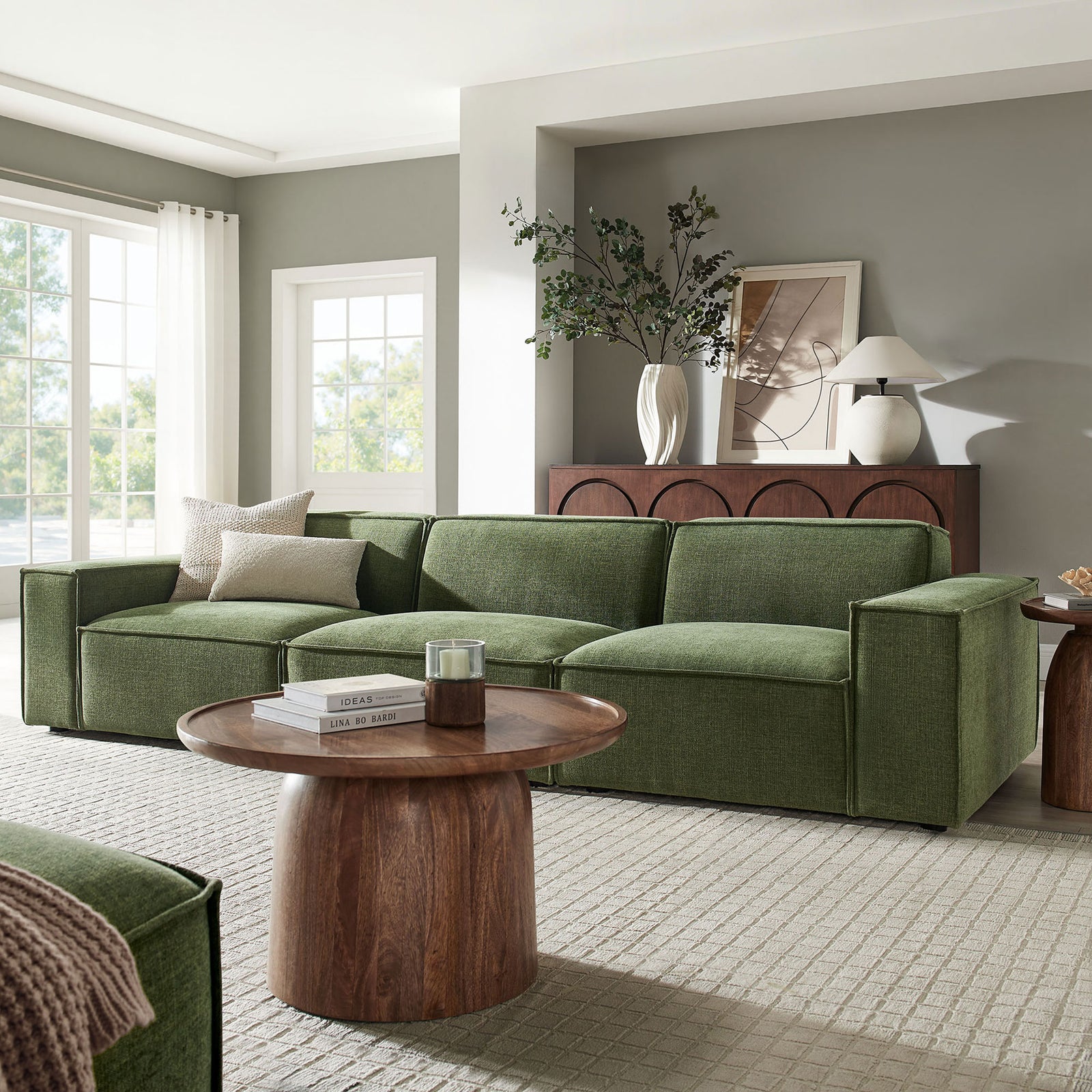 Three-piece foliage green sectional arranged in a bright living room with wood coffee table and decor || EEI-7407-FOL || front_angle_room