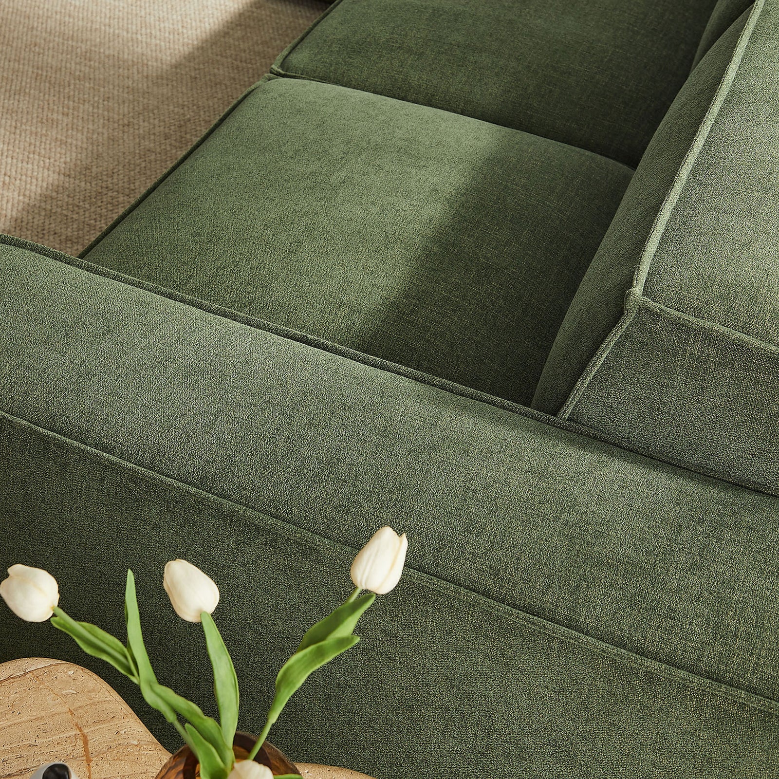 Foliage green armrest and cushions highlighting the sofa's soft performance fabric and refined French piping. || EEI-7411-FOL || detail_room