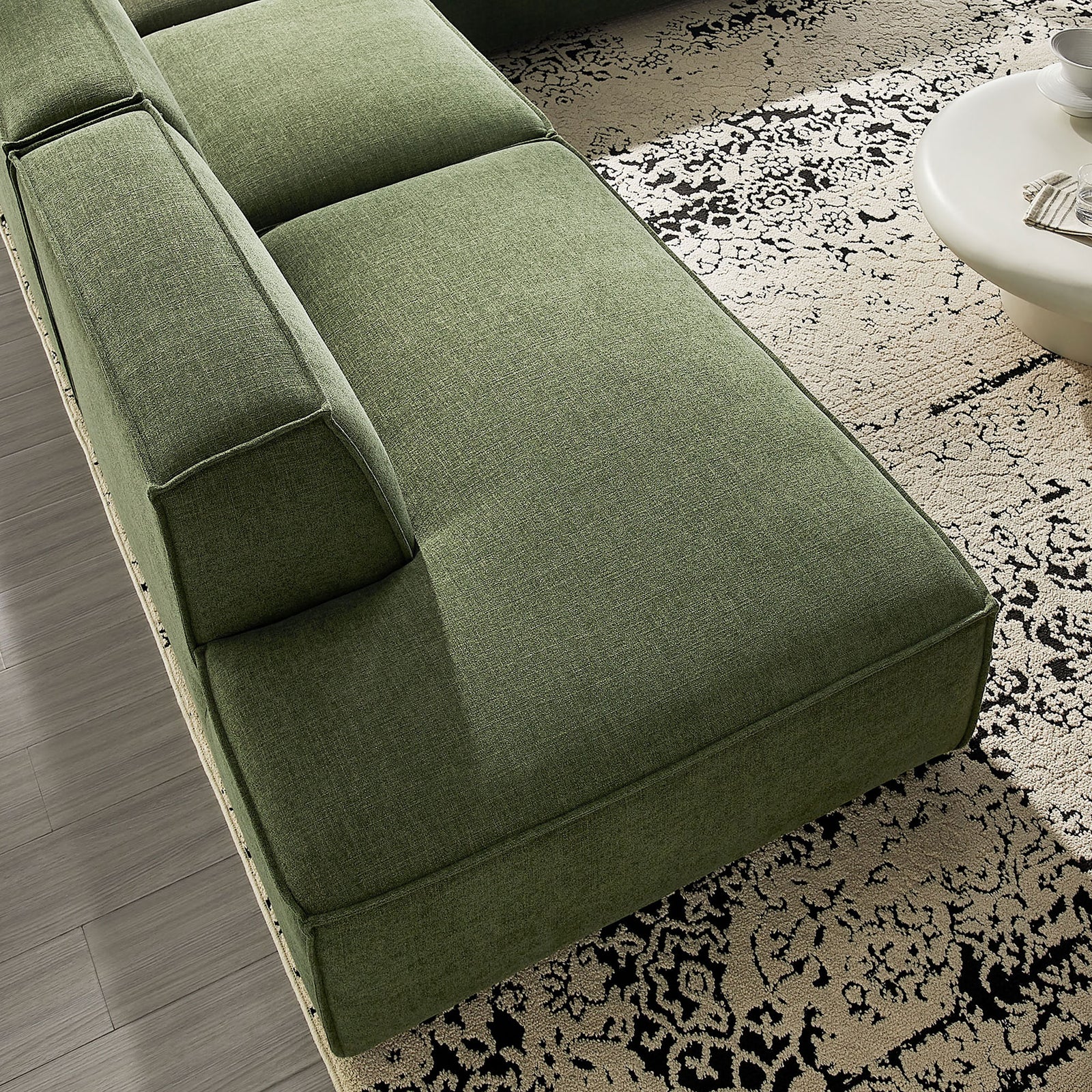 Green performance fabric chaise section with deep seat cushion and crisp French piping detail. || EEI-7413-FOL || detail_room