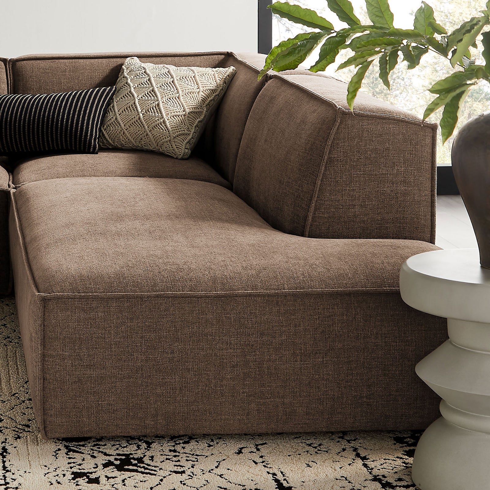 Mocha sectional corner with plush seating, accent pillows, and a sculptural side table || EEI-7413-MOC || detail_room