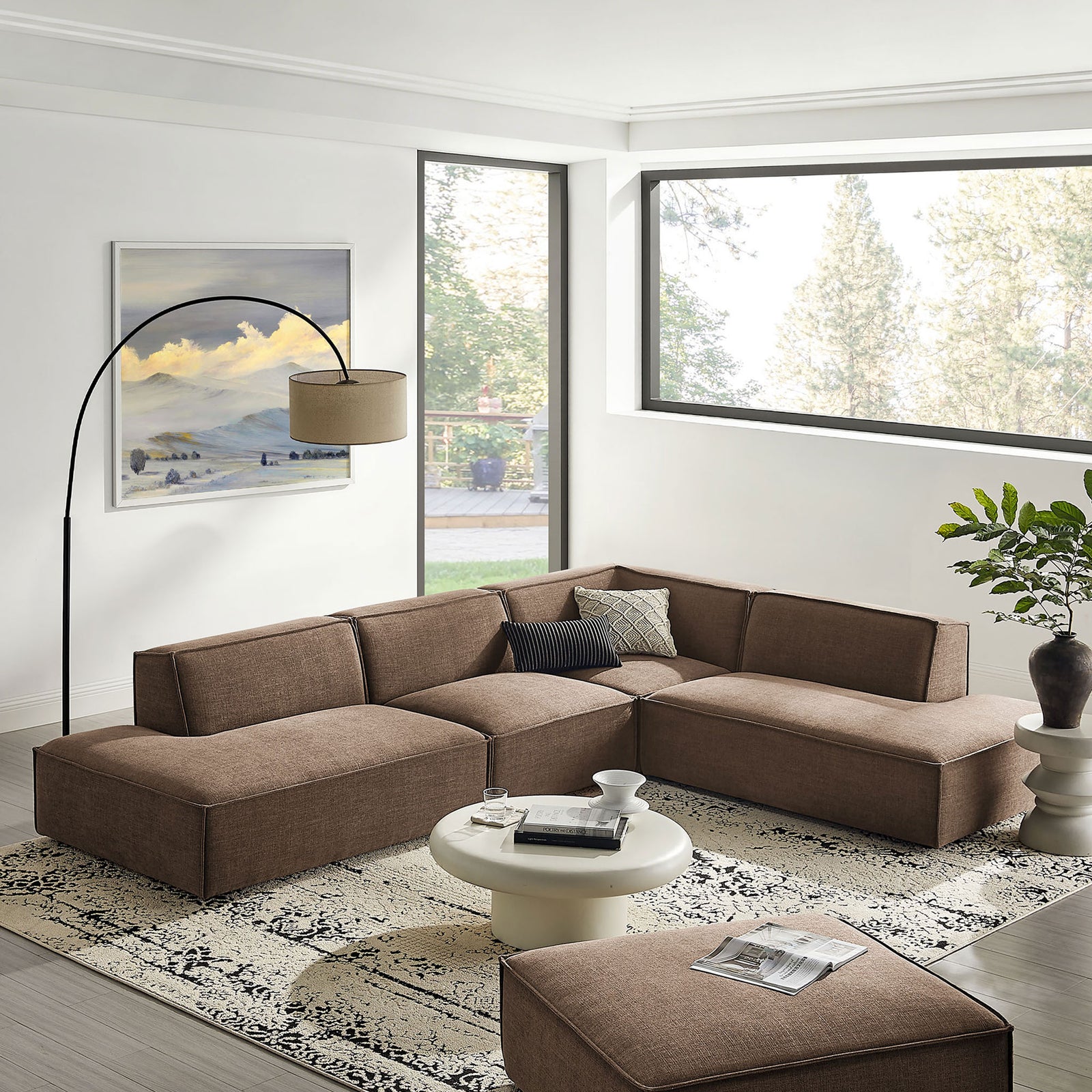 Mocha modular L-shaped sectional anchoring a bright living room with modern decor and rug || EEI-7413-MOC || front_angle_room