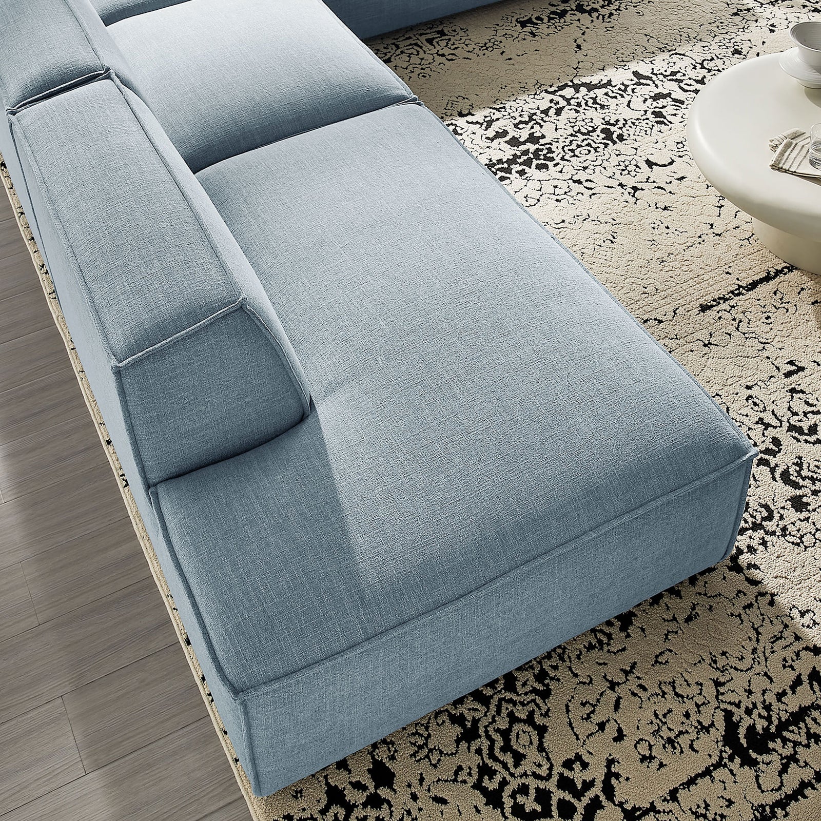 Close-up of sky blue chaise seat highlighting the smooth performance fabric texture and plush cushioning. || EEI-7413-SKY || detail_room
