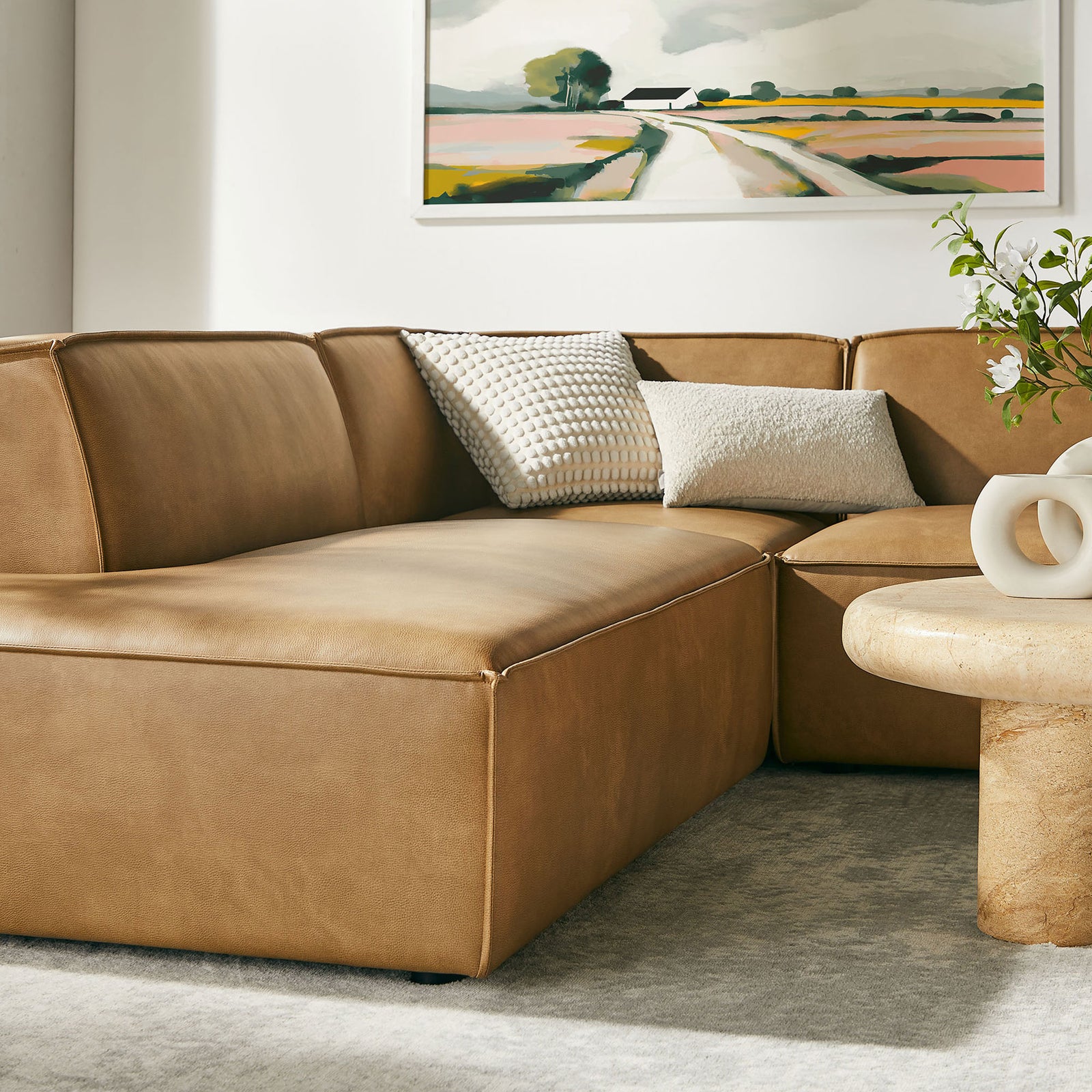 Toast vegan leather chaise section accented with neutral pillows in a modern living room || EEI-7416-TST || detail_room