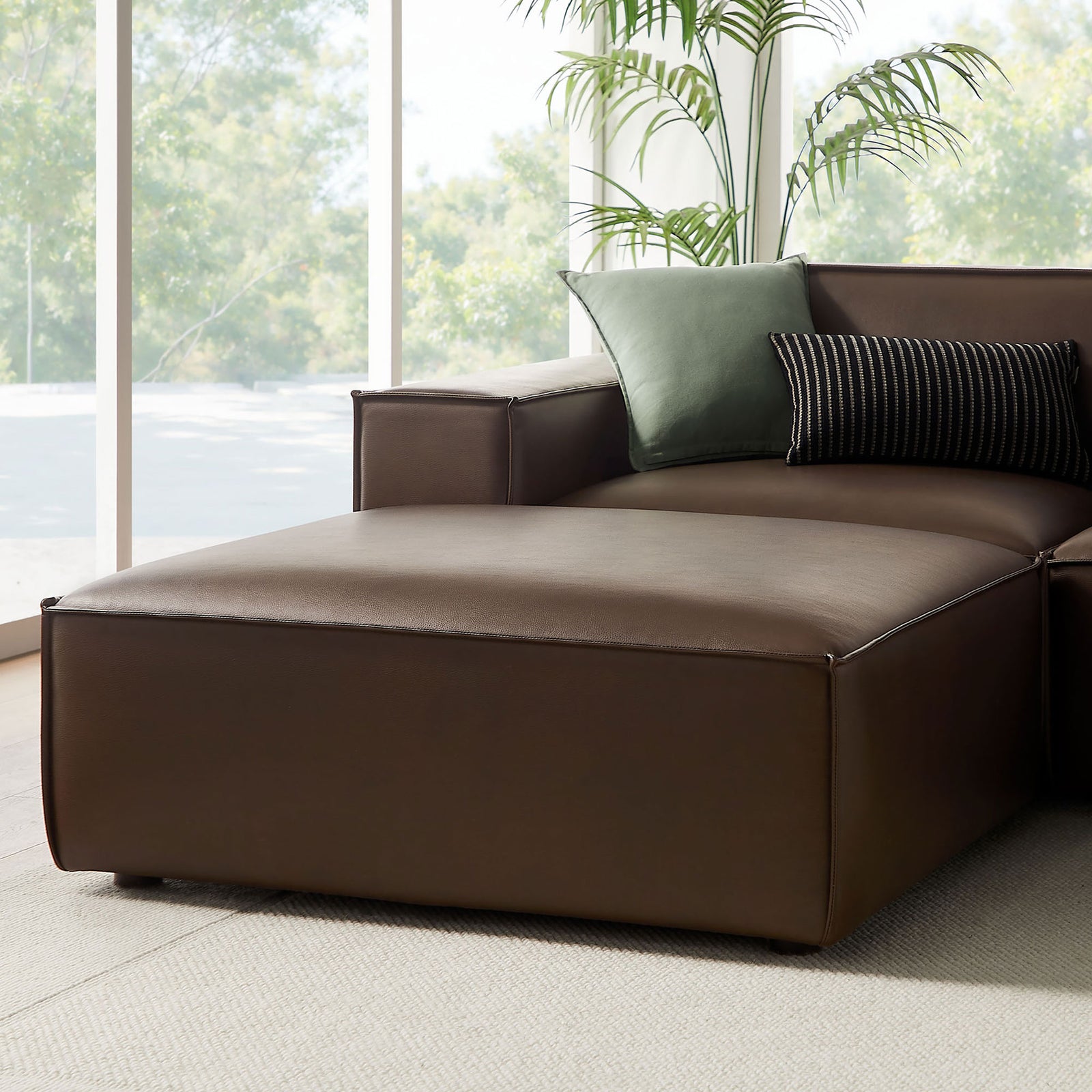 Espresso chaise end of the modular sectional styled with accent pillows for relaxed lounging || EEI-7418-ESP || detail_room
