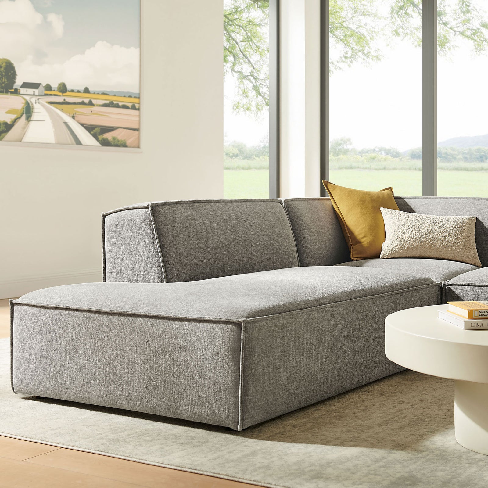 Left-facing chaise lounge section in pewter fabric, accented with layered throw pillows in a bright living room. || EEI-7419-PEW || front_angle_partial_room
