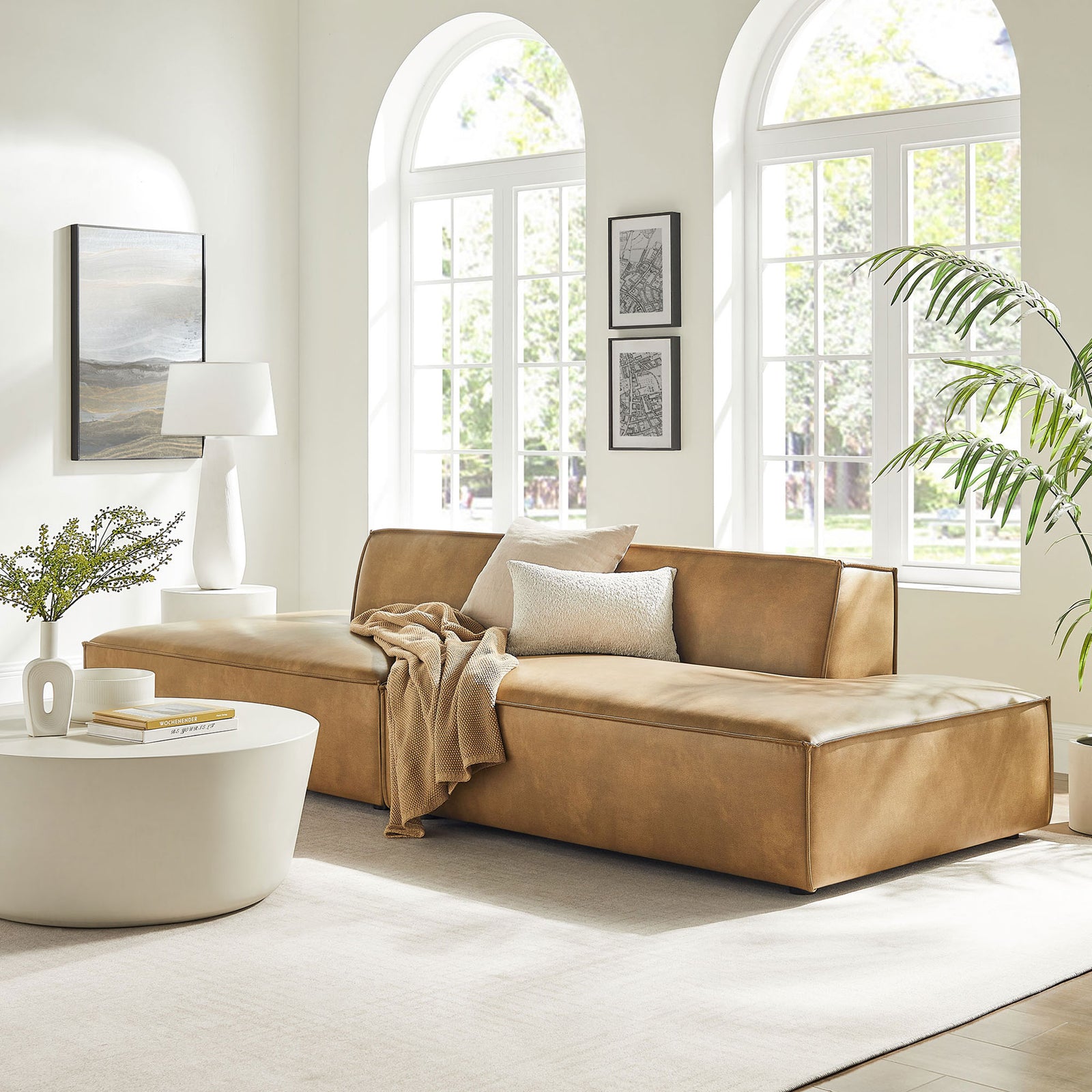 Restore modular loveseat in a bright living room, offering low-profile lounge seating in warm toast vegan leather. || EEI-7424-TST || front_angle_room