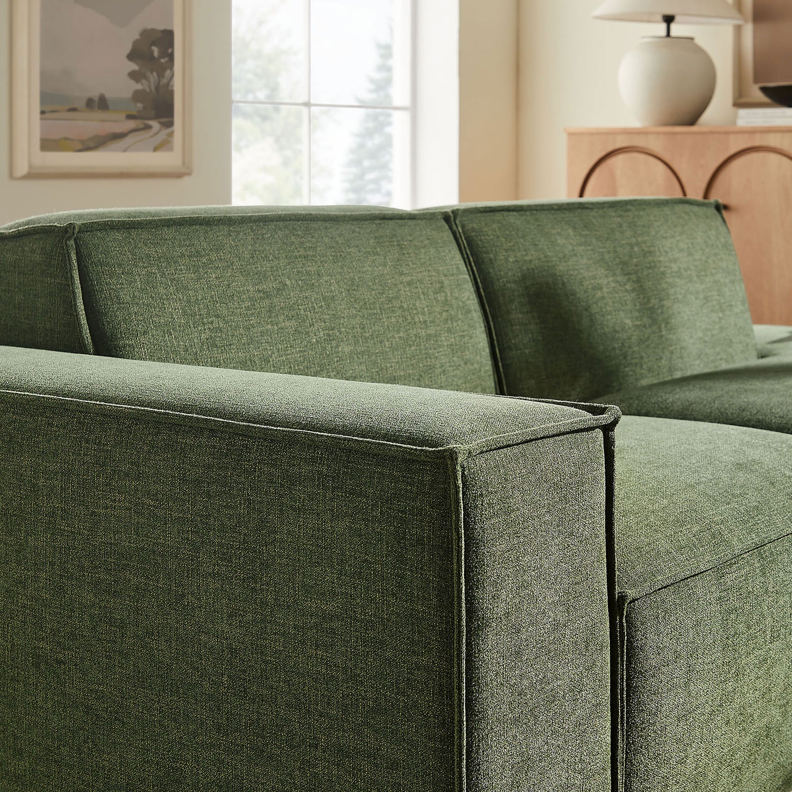 Left armrest showcases crisp French piping and textured foliage green performance fabric || EEI-7425-FOL || detail_room