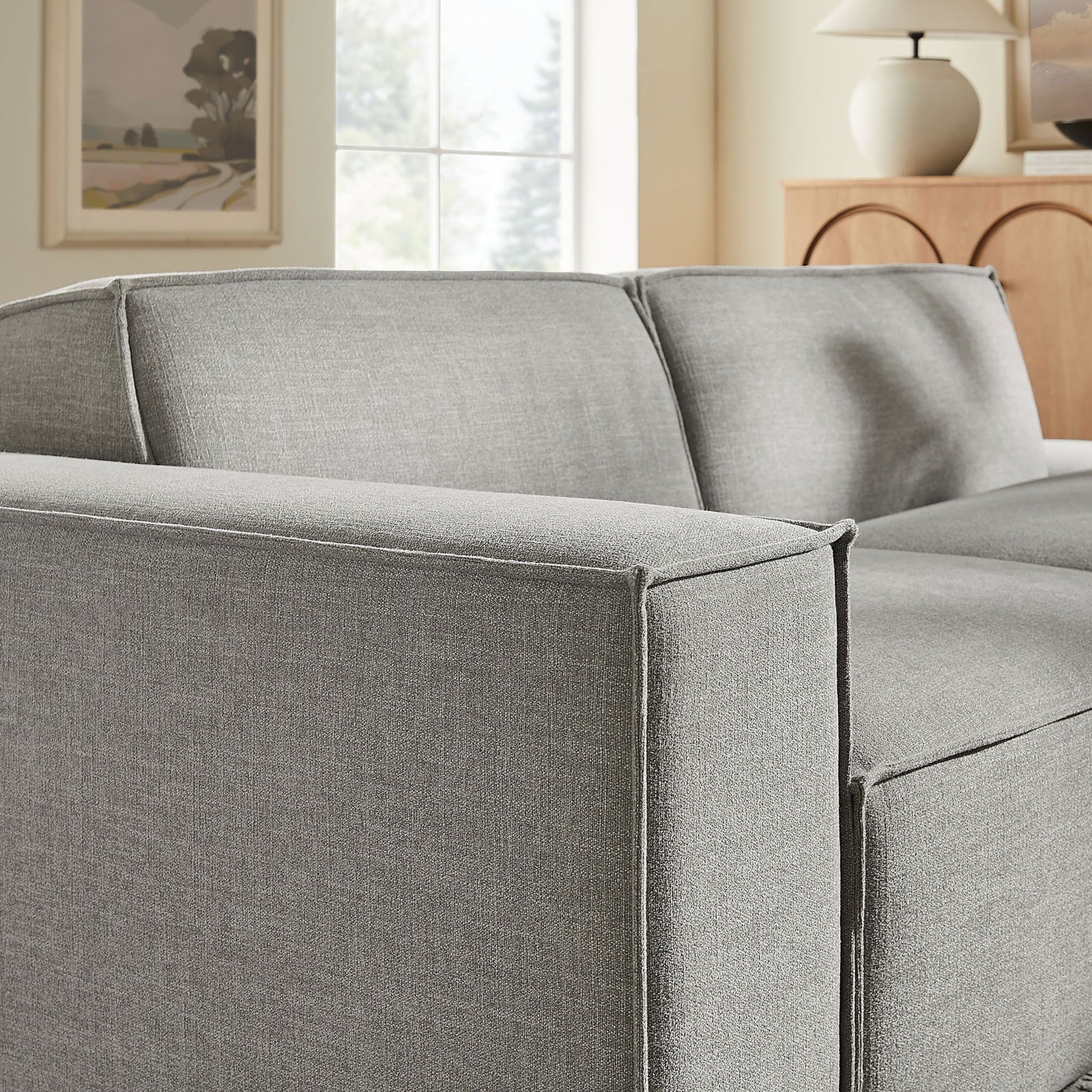 Close-up of loveseat arm and back cushions with tailored French piping in pewter performance fabric. || EEI-7425-PEW || detail_room