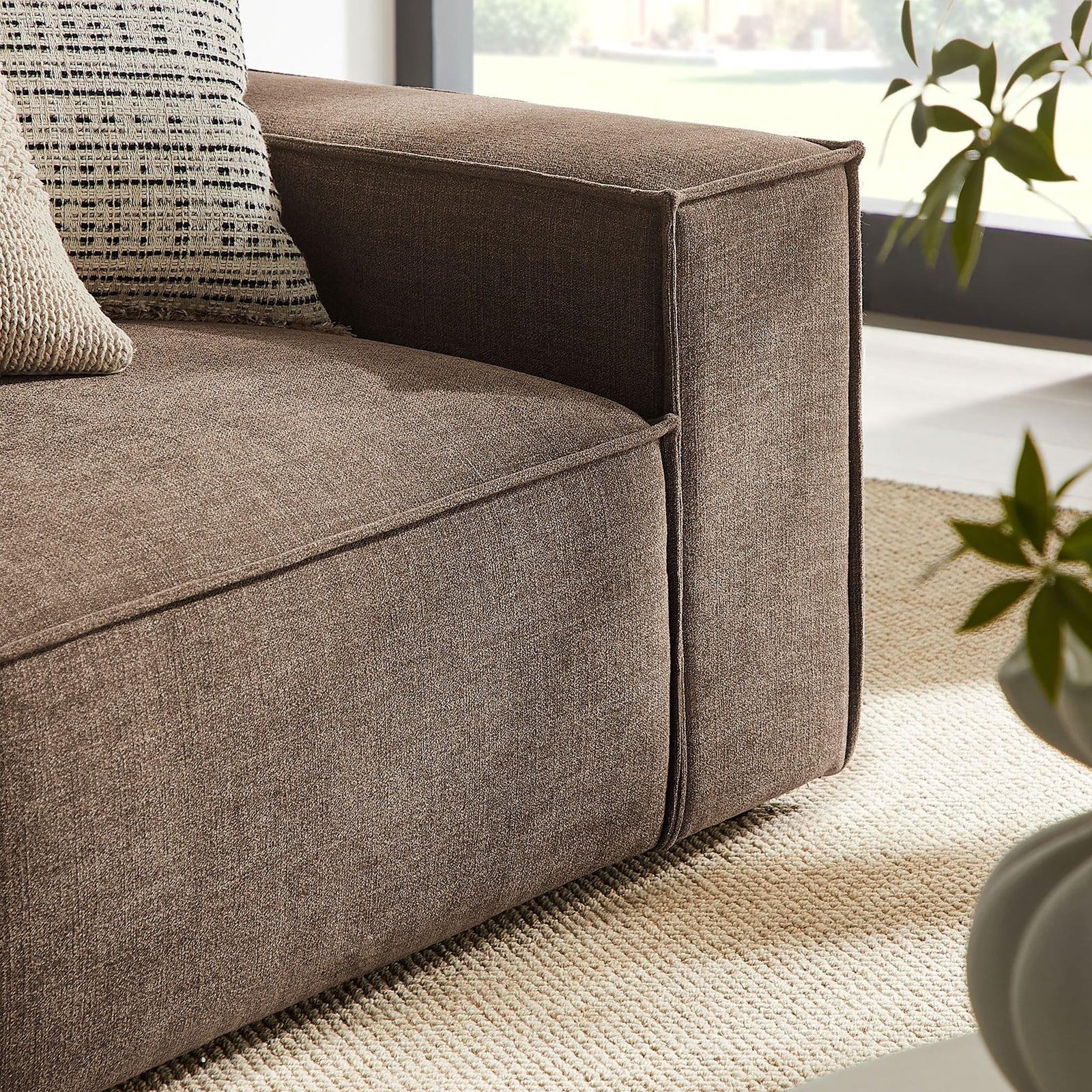 Right arm detail with tailored piping, accent pillows, and textured mocha performance fabric || EEI-7427-MOC || detail_room