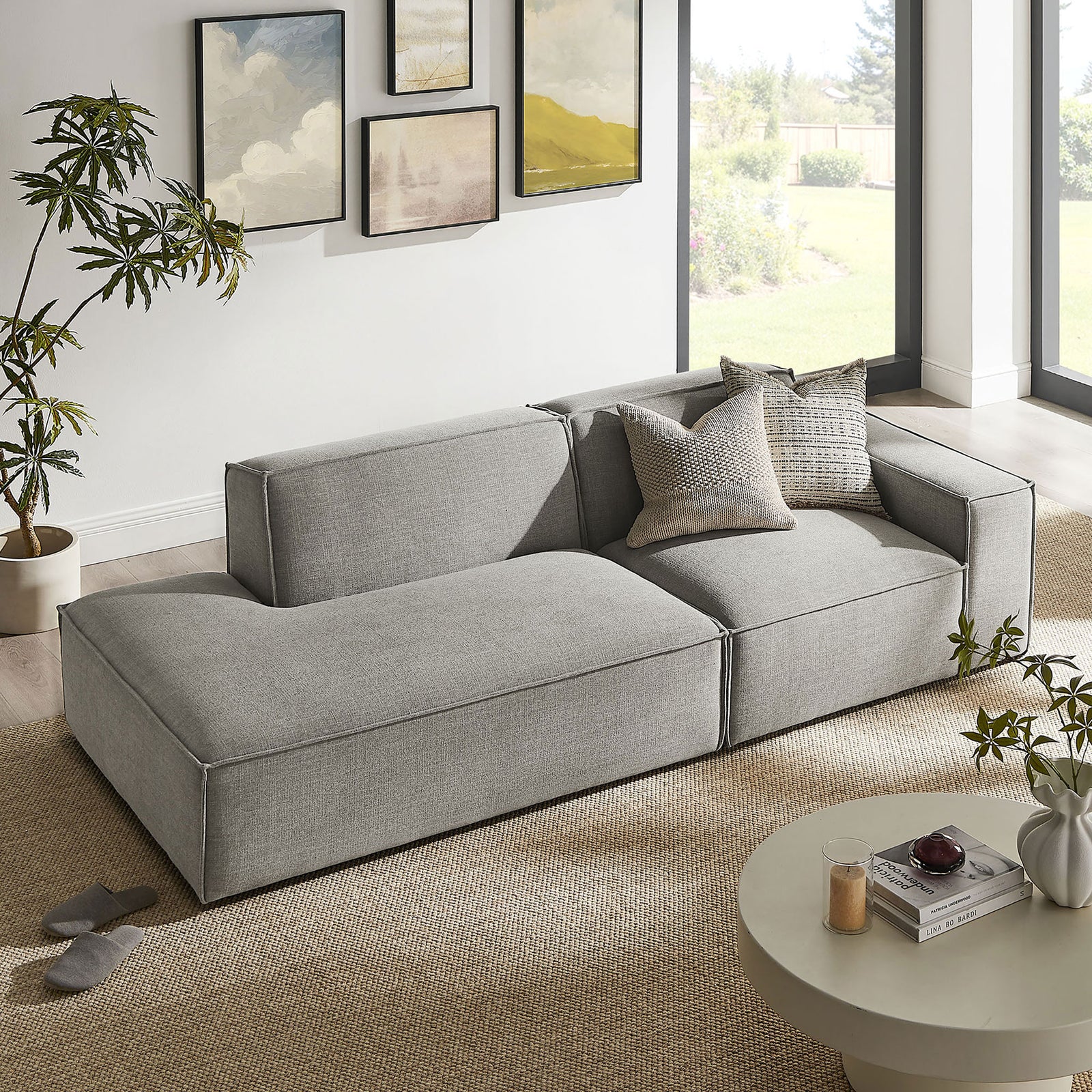 Pewter modular loveseat arranged in a modern living room with neutral rug, art, and greenery. || EEI-7427-PEW || front_angle_room