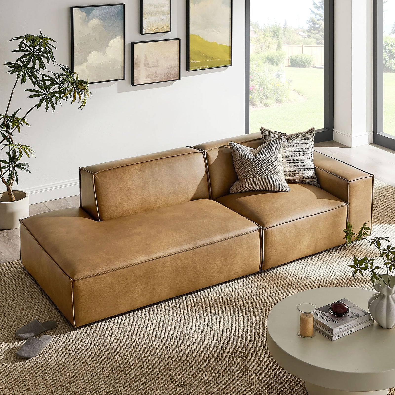 Modular loveseat arranged in a sunny living space with layered pillows and a relaxed, low-slung profile. || EEI-7428-TST || front_angle_room