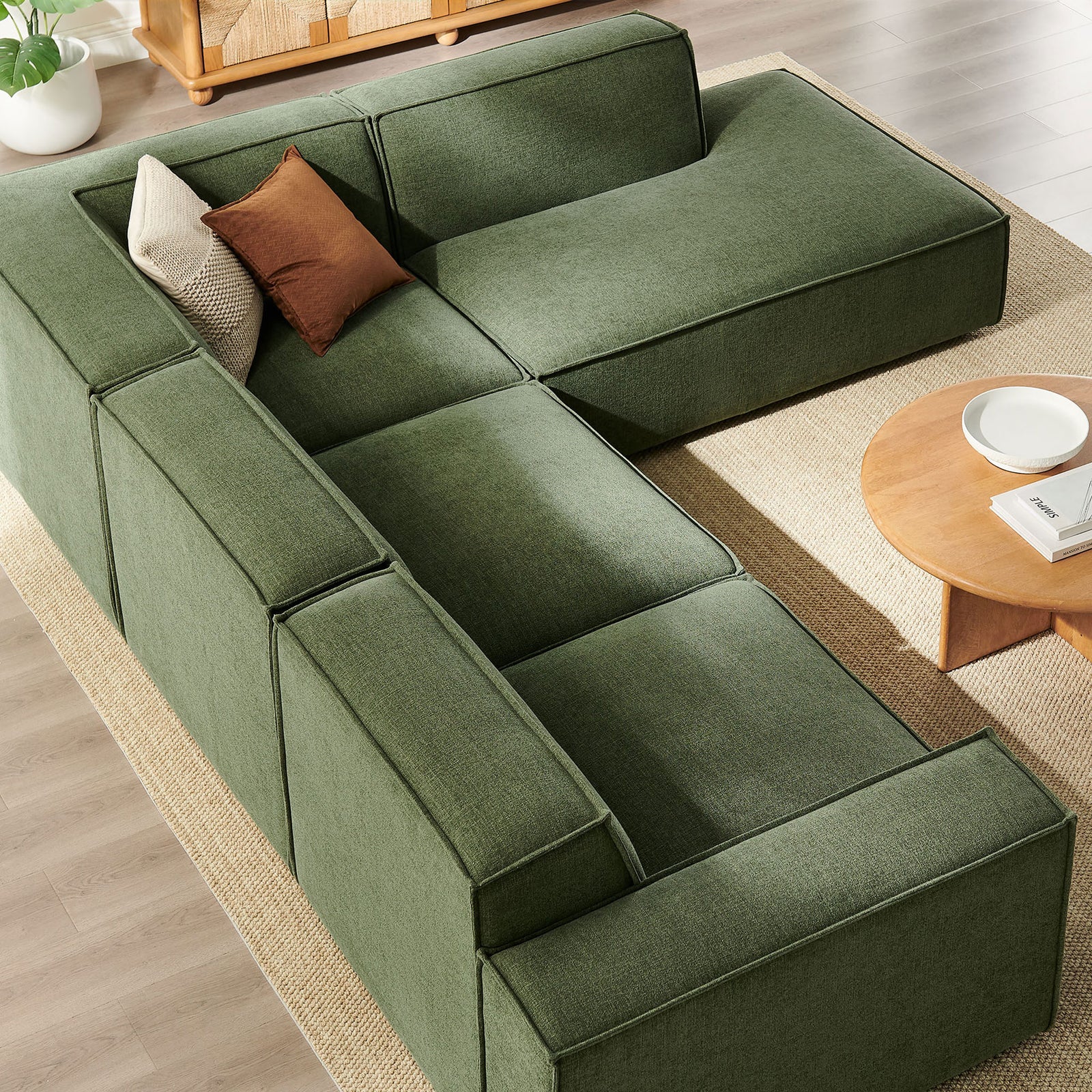 Spacious Restore foliage green chaise sectional arranged with minimalist coffee table and large windows for airy feel || EEI-7429-FOL || top_angle_room