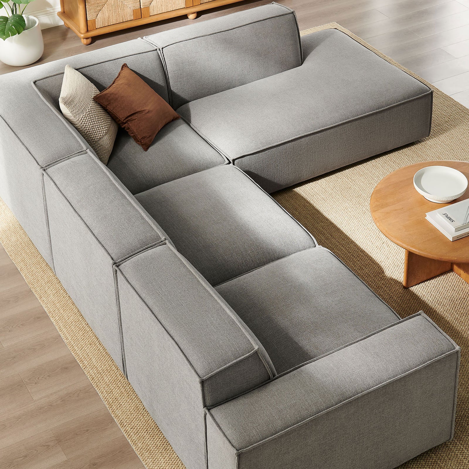 Generous seat cushions and extended chaise form an inviting lounging nook on this pewter modular sofa || EEI-7429-PEW || top_angle_room