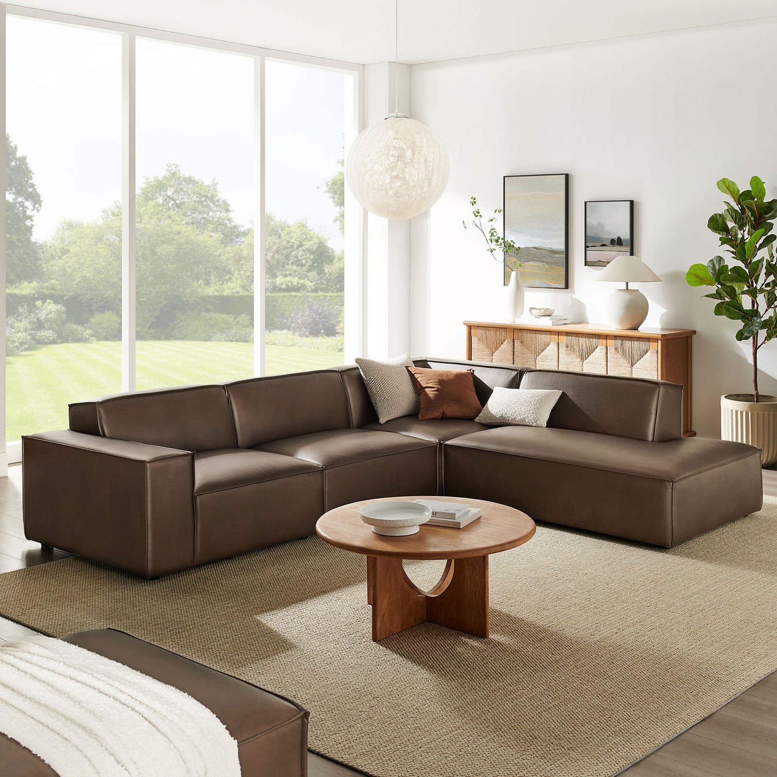 Espresso vegan leather L-shaped sectional with right chaise styled in a bright living room with neutral rug and modern wood coffee table || EEI-7430-ESP || front_angle_room