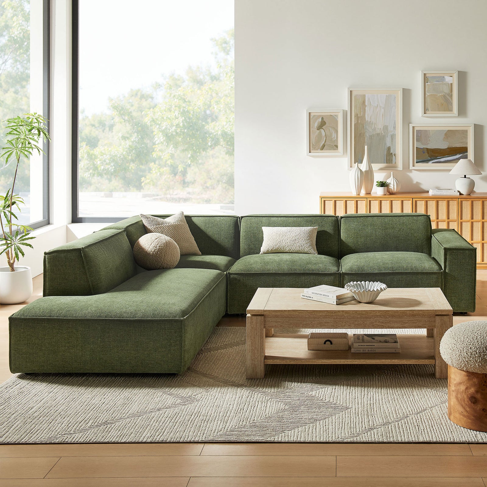Restore foliage green modular sectional with left-facing chaise styled with pillows, rug, and light wood accents || EEI-7431-FOL || front_angle_room