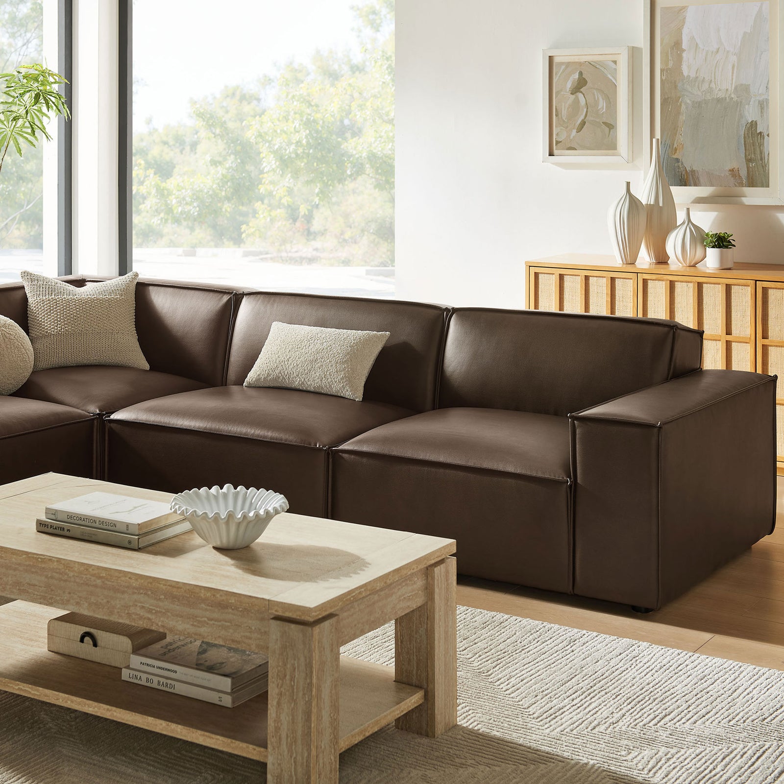 Restore espresso vegan leather sectional showcasing the left chaise and wide track arm beside a modern wood coffee table || EEI-7432-ESP || front_angle_room