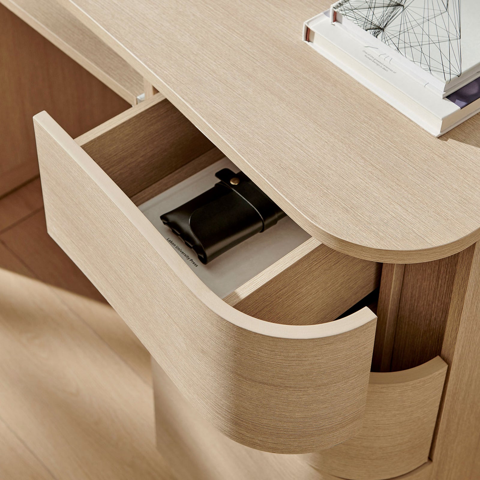Deep side drawer with curved front neatly organizes everyday essentials in a warm light oak finish. || EEI-7436-BOA || storage_open_room