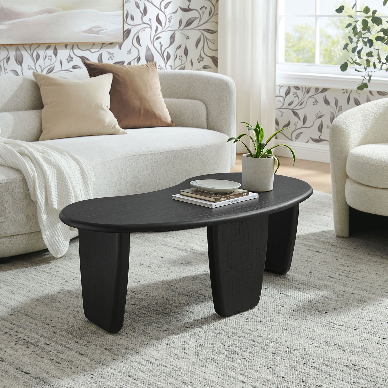 Kidney-shaped black coffee table brings soft curves and mid-century warmth to a modern living room || EEI-7437-BLK || front_angle_room