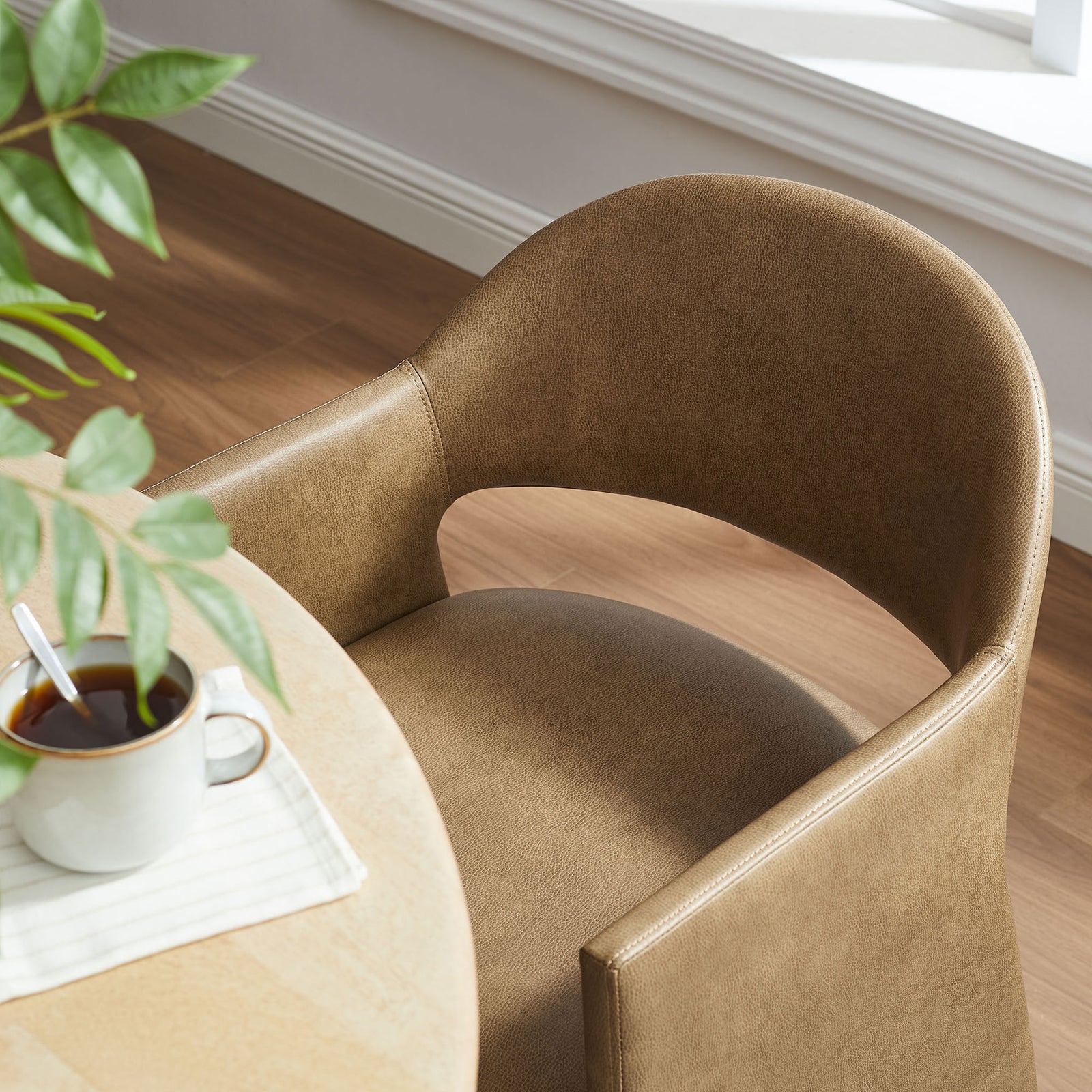 Toast vegan leather dining chair paired with a round table, bringing warm modern style to your space || EEI-7442-TST || detail_room