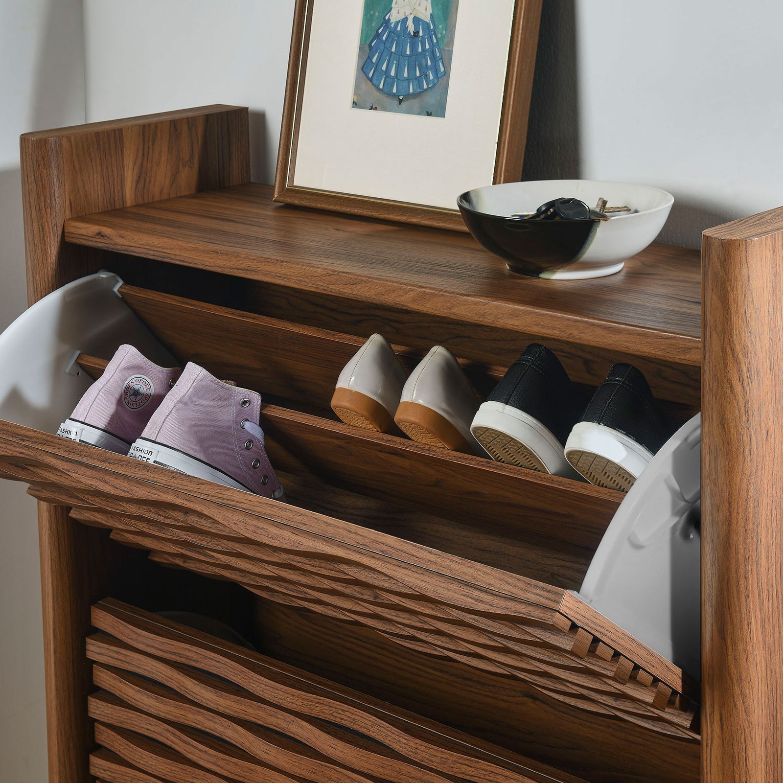 Shoe cabinet in use with sneakers and heels stored neatly in the flip down compartments in an entryway || EEI-7447-WAL || front_angle_open_room