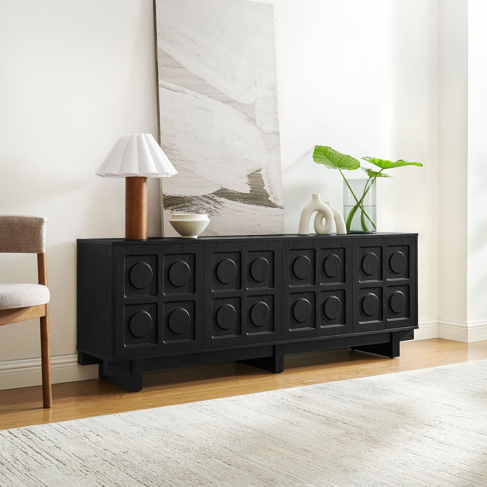 Black Knox TV stand styled as a modern credenza with art, lamp, and vases in a warm living room || EEI-7450-BLK || front_angle_room