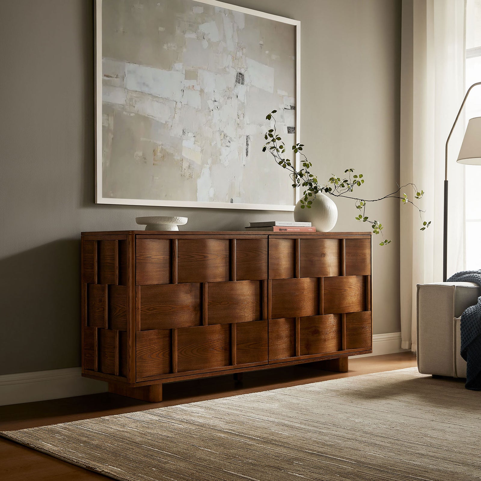 Walnut woven-front buffet anchors a warm living room vignette with art, rug, and sculptural decor || EEI-7452-WAL || front_room