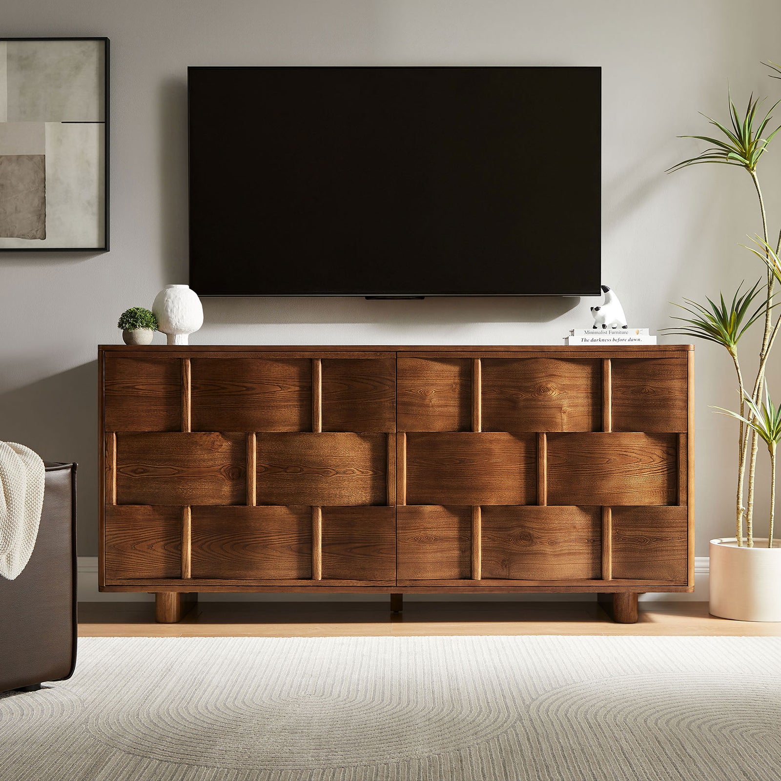 Walnut buffet serves as a media console beneath a wall-mounted TV with plants and soft textures || EEI-7452-WAL || front_room