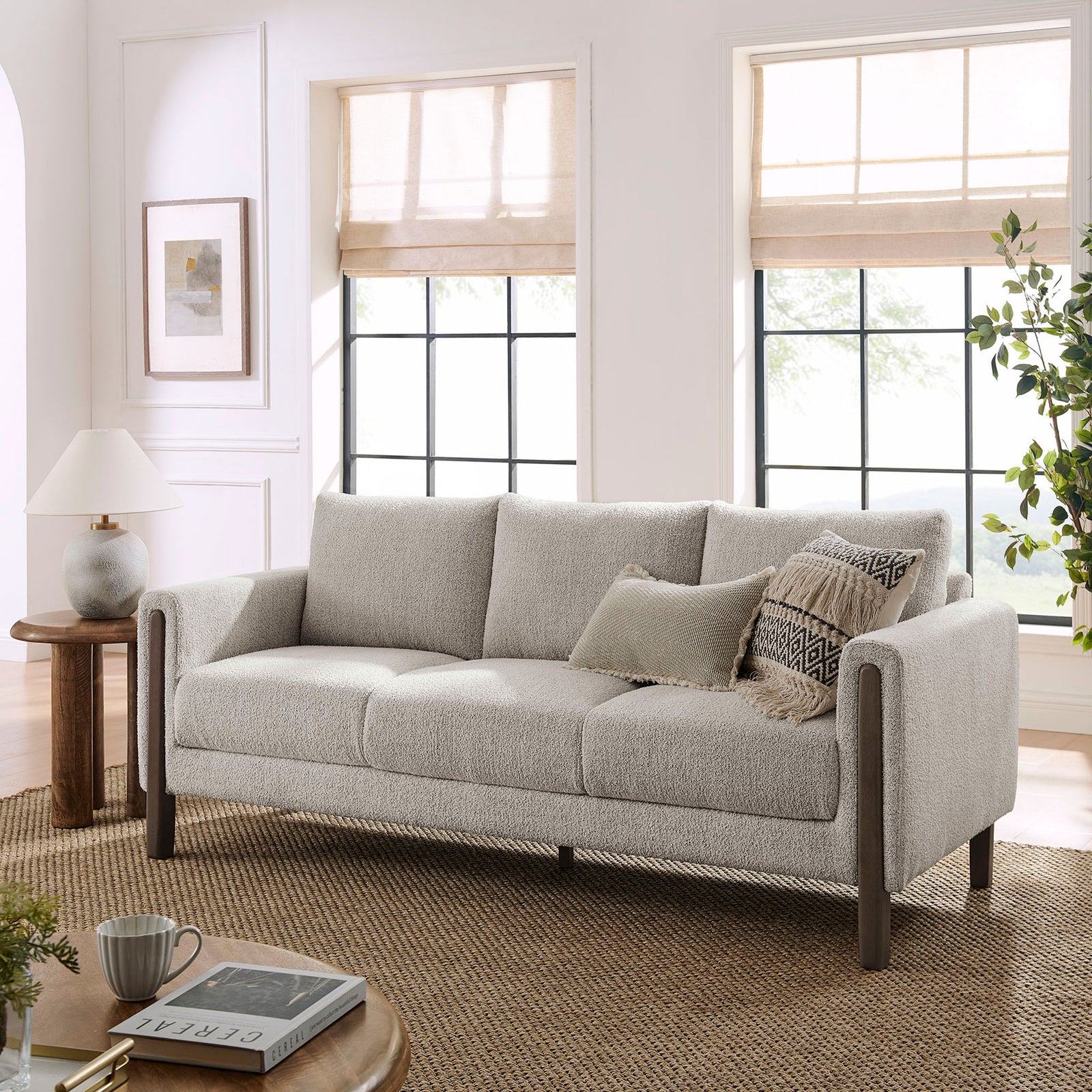 Boucle sofa styled in a bright living room with layered pillows and espresso wood legs || EEI-7461-PCH-ESP || front_angle_room