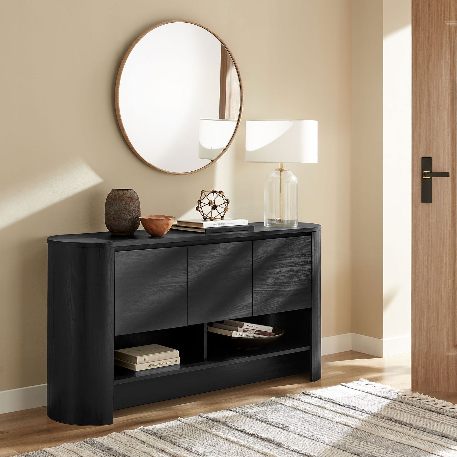 Duval sideboard used as an entry console with modern decor accents, books, and a glass table lamp || EEI-7478-BLK || front_angle_room