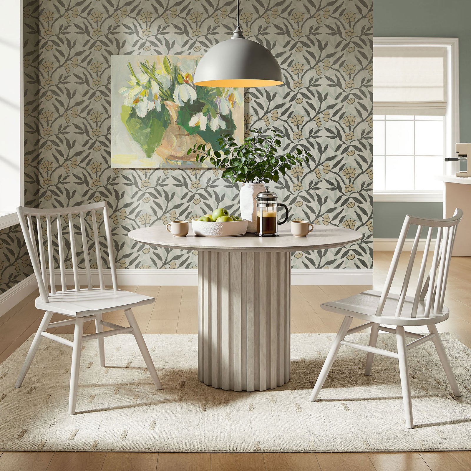 Pair of white wash spindle back dining chairs around a round pedestal table || EEI-7482-WWA || front_angle_multi_room