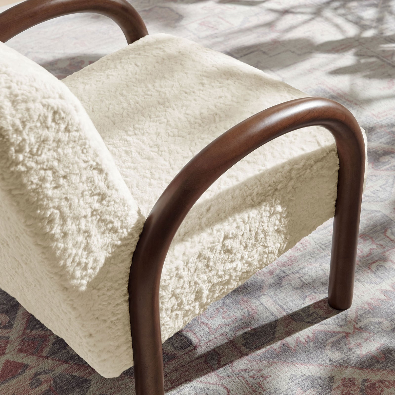 Faux shearling texture and smooth wood arcs bring rich contrast and inviting tactility || EEI-7488-ECR || detail_room