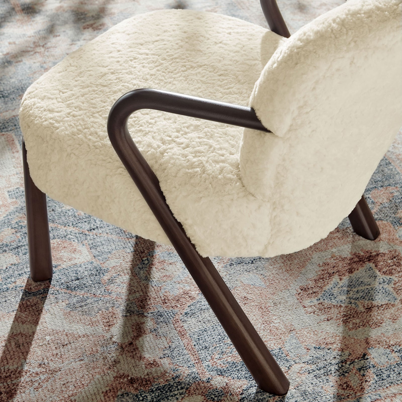 Soft teddy-like texture pairs with warm wood curves for a cozy, modern living room accent. || EEI-7489-ECR || detail_room