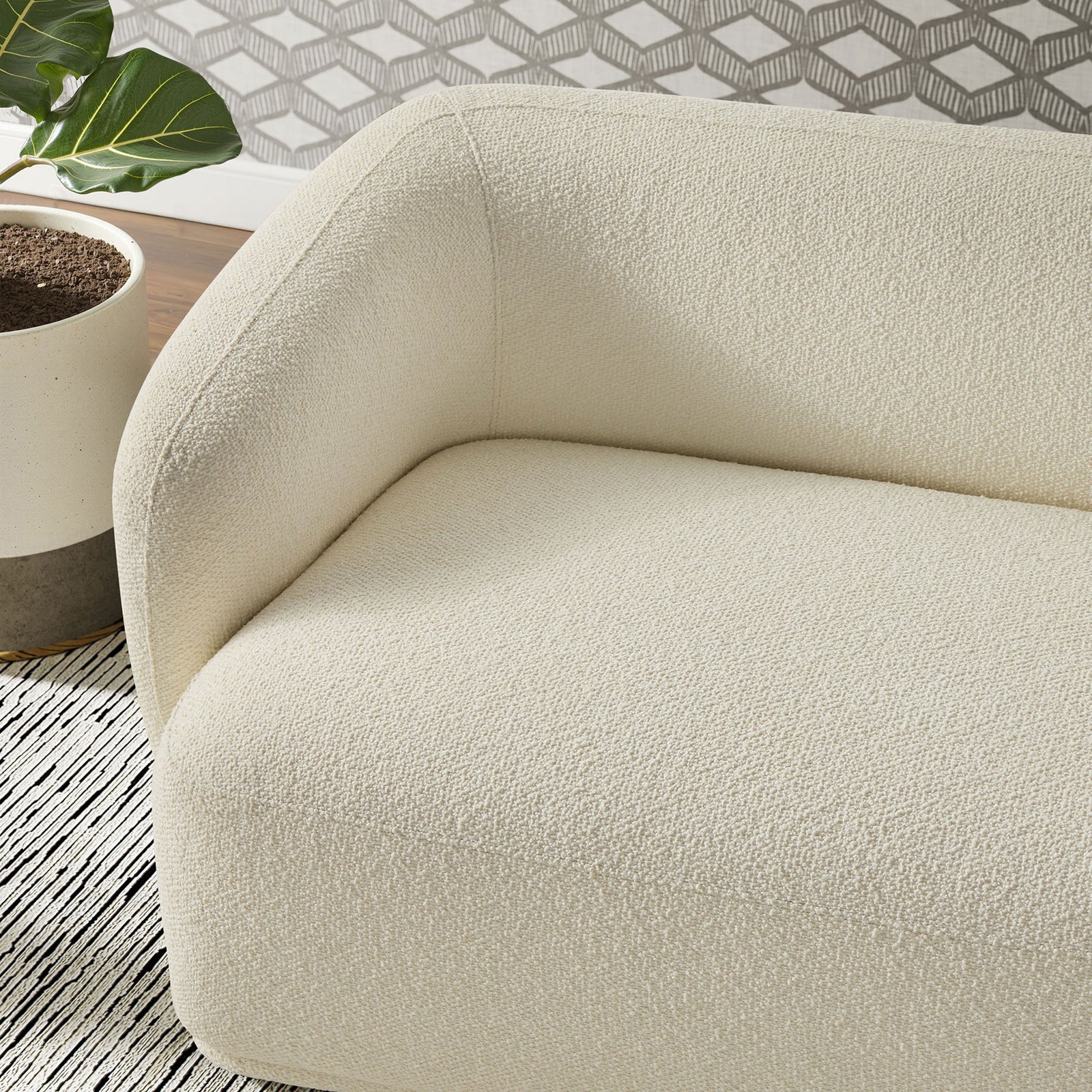 Boucle fabric and deep seat cushioning create a cozy spot on this cream Monica sofa || EEI-7501-CRE || detail_room