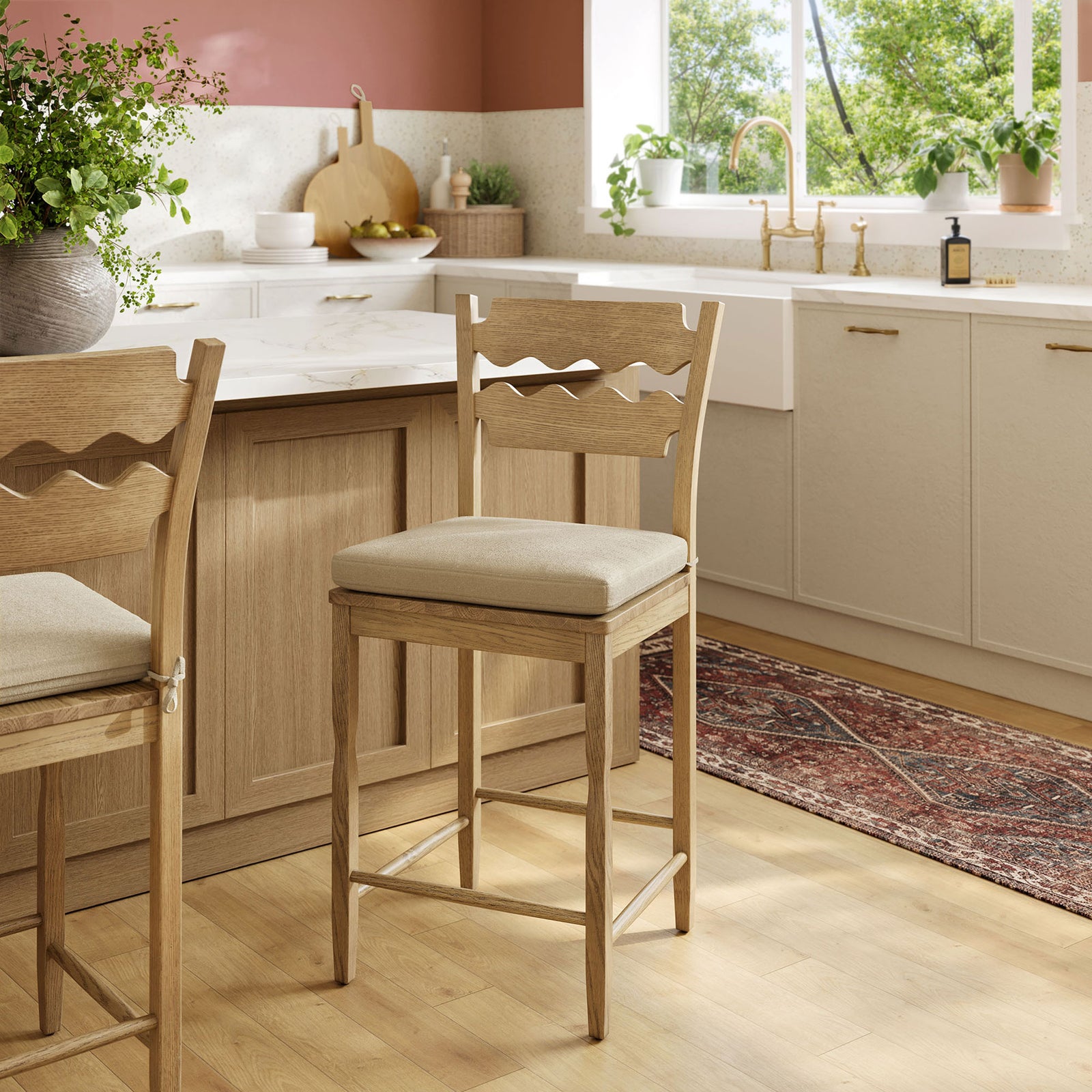 Styled at the kitchen island, the counter stool adds warmth with its oak grain and soft cushion || EEI-7518-WOA-LIN || front_angle_room