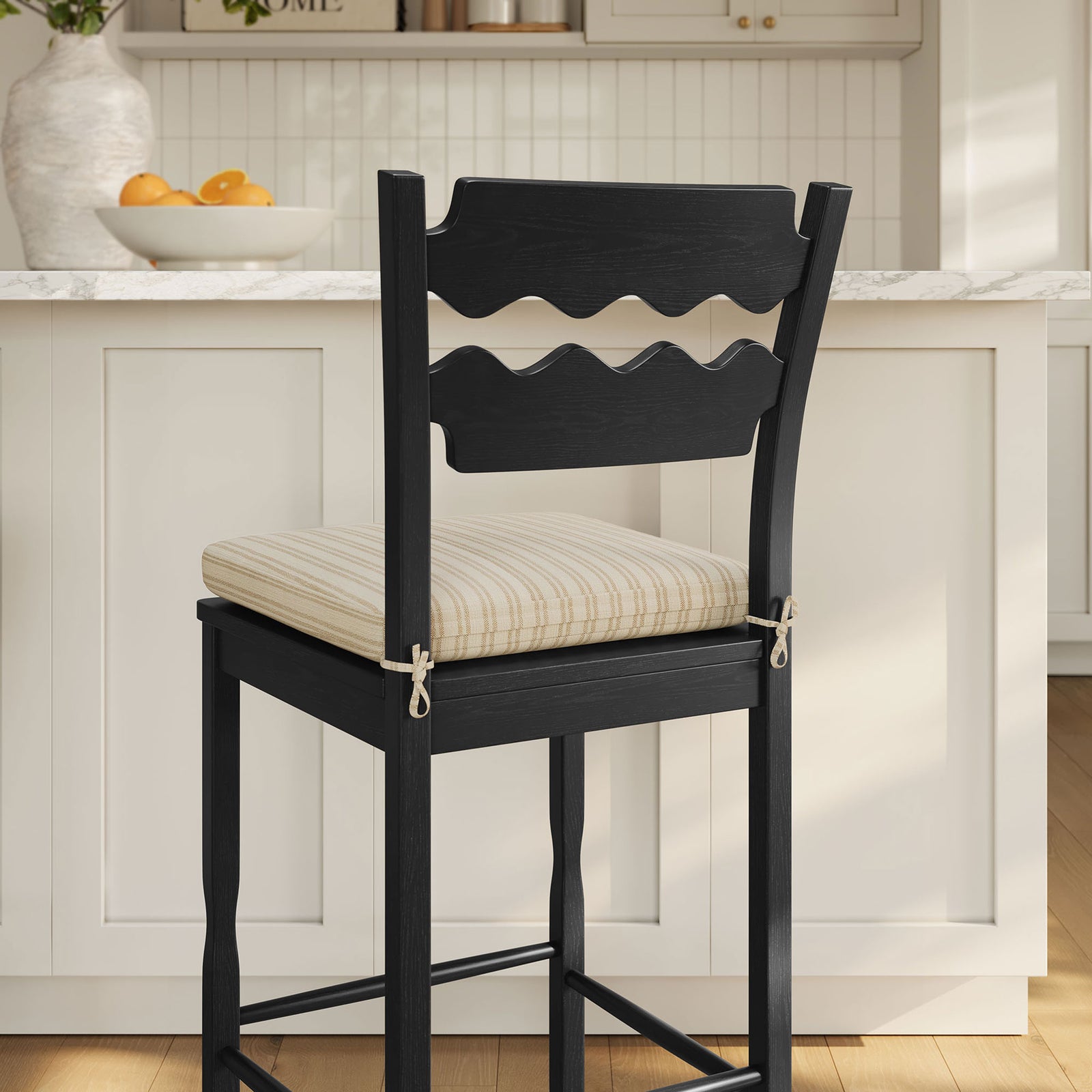 Cushion ties and deep black wood grain bring contrast in a bright kitchen. || EEI-7519-BLK-OAS || detail_room