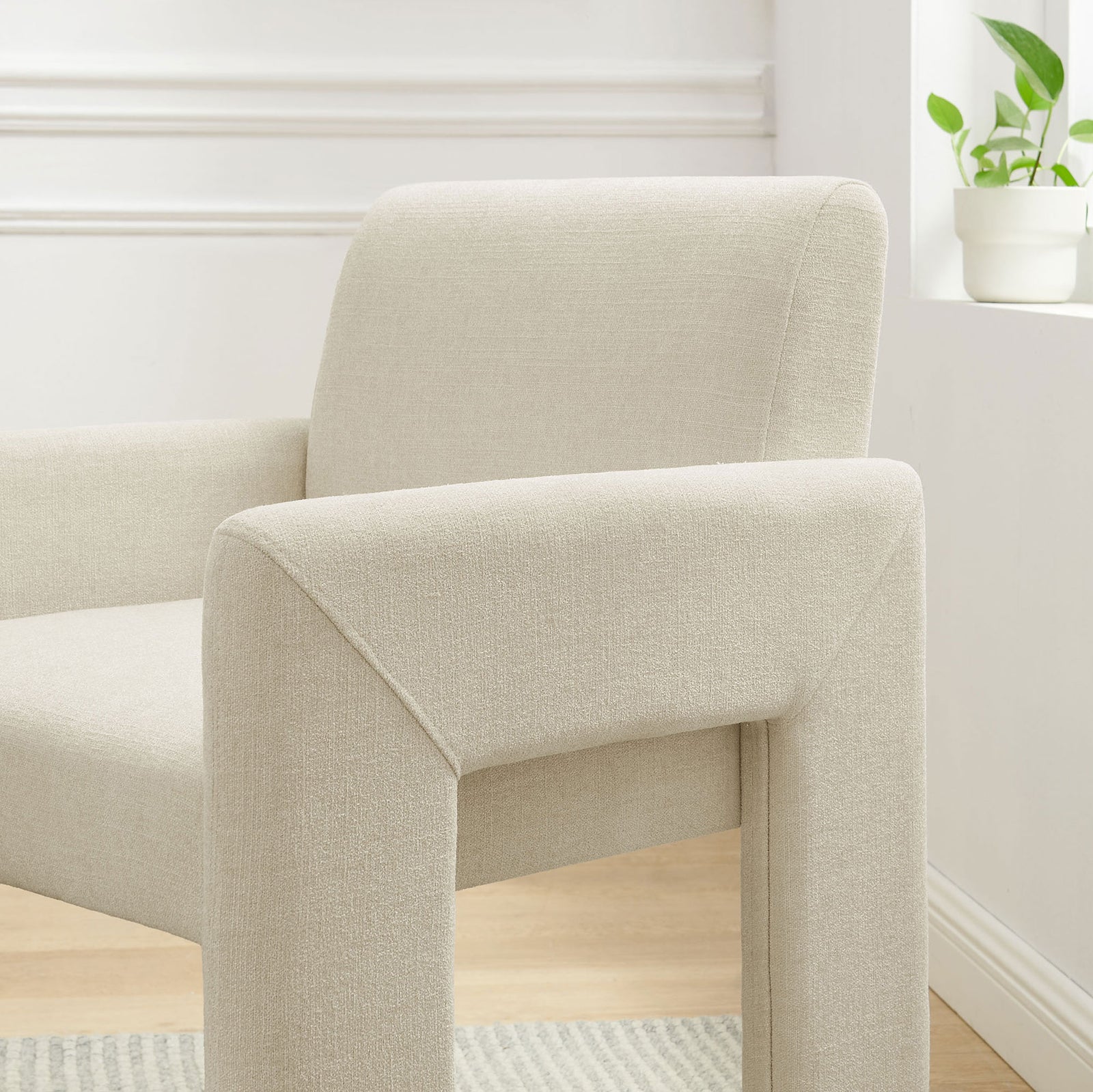 Ecru Daven armchair styled in a bright dining nook, highlighting its plush back cushion and slim arms || EEI-7524-ECR || detail_room