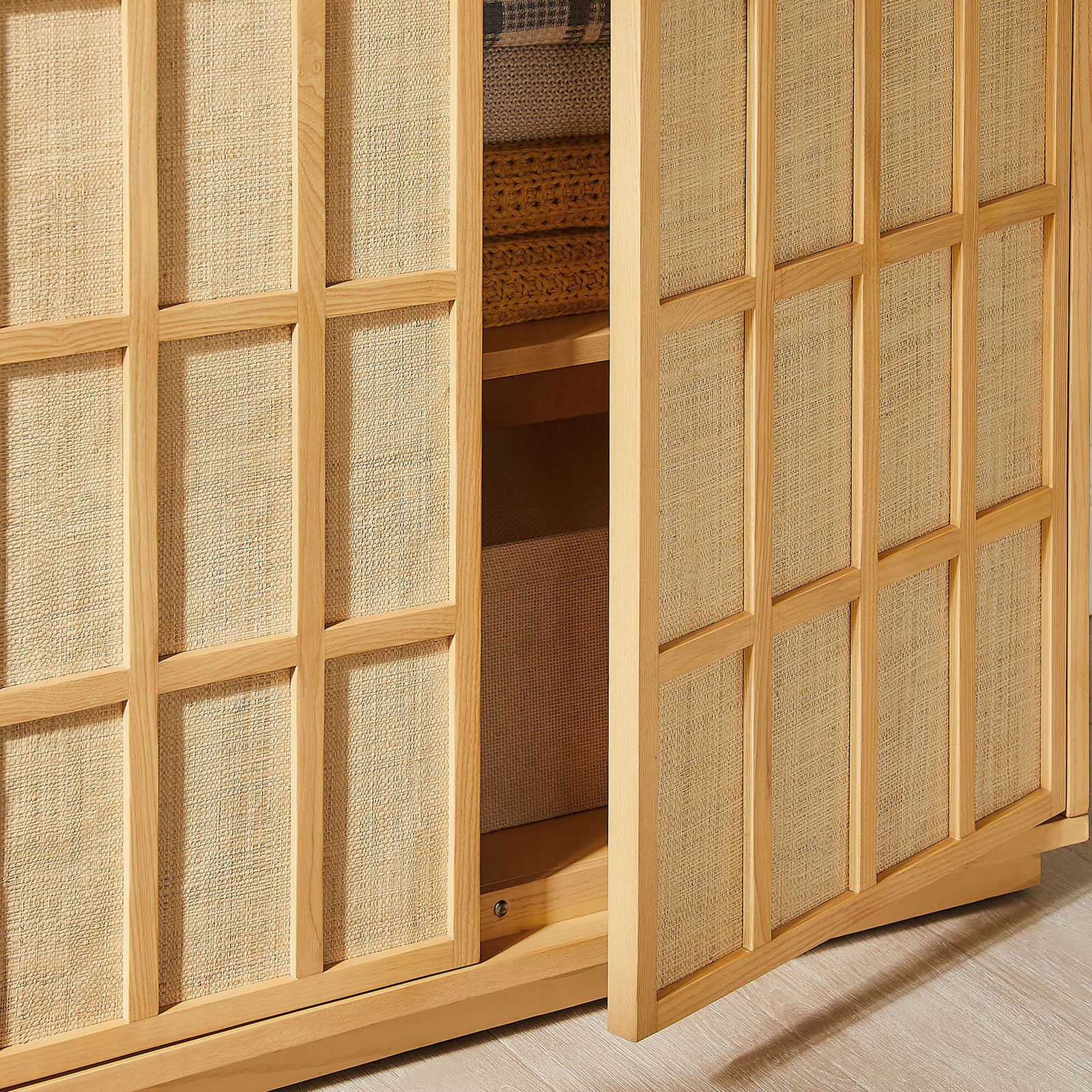 Tall cabinet partially opened to show styled shelves with baskets, textiles, and decor in a cozy room || EEI-7560-LOA || storage_open_room