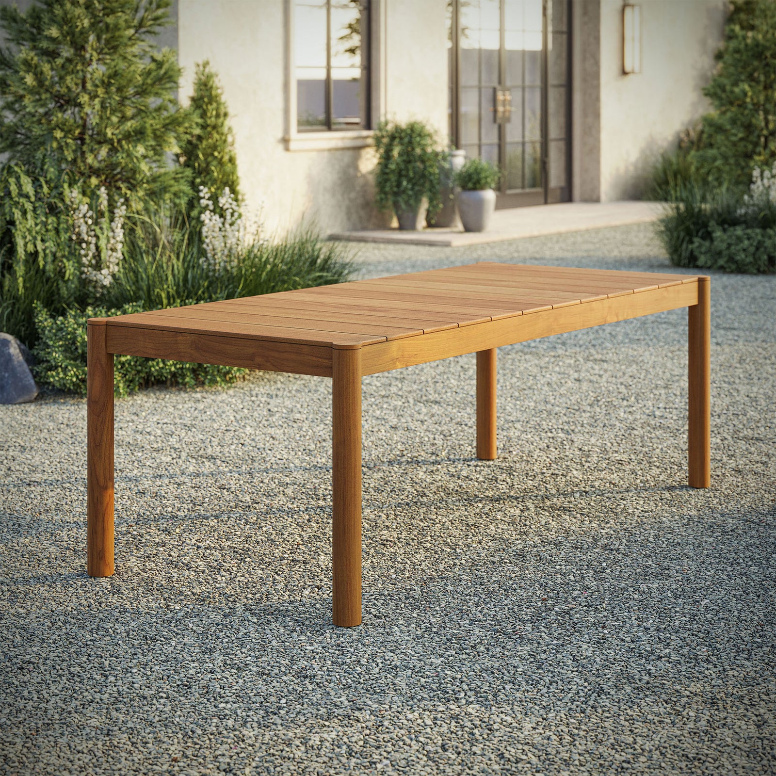 Eleni 89 inch natural teak outdoor dining table styled on a spacious patio ready for open air meals || EEI-7562-NAT || front_angle_room
