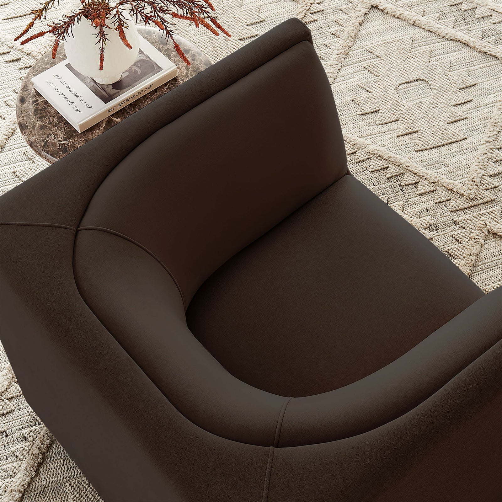 Velvet curves bring warm texture beside a sculptural table in a relaxed living space || EEI-7566-CHB || detail_room