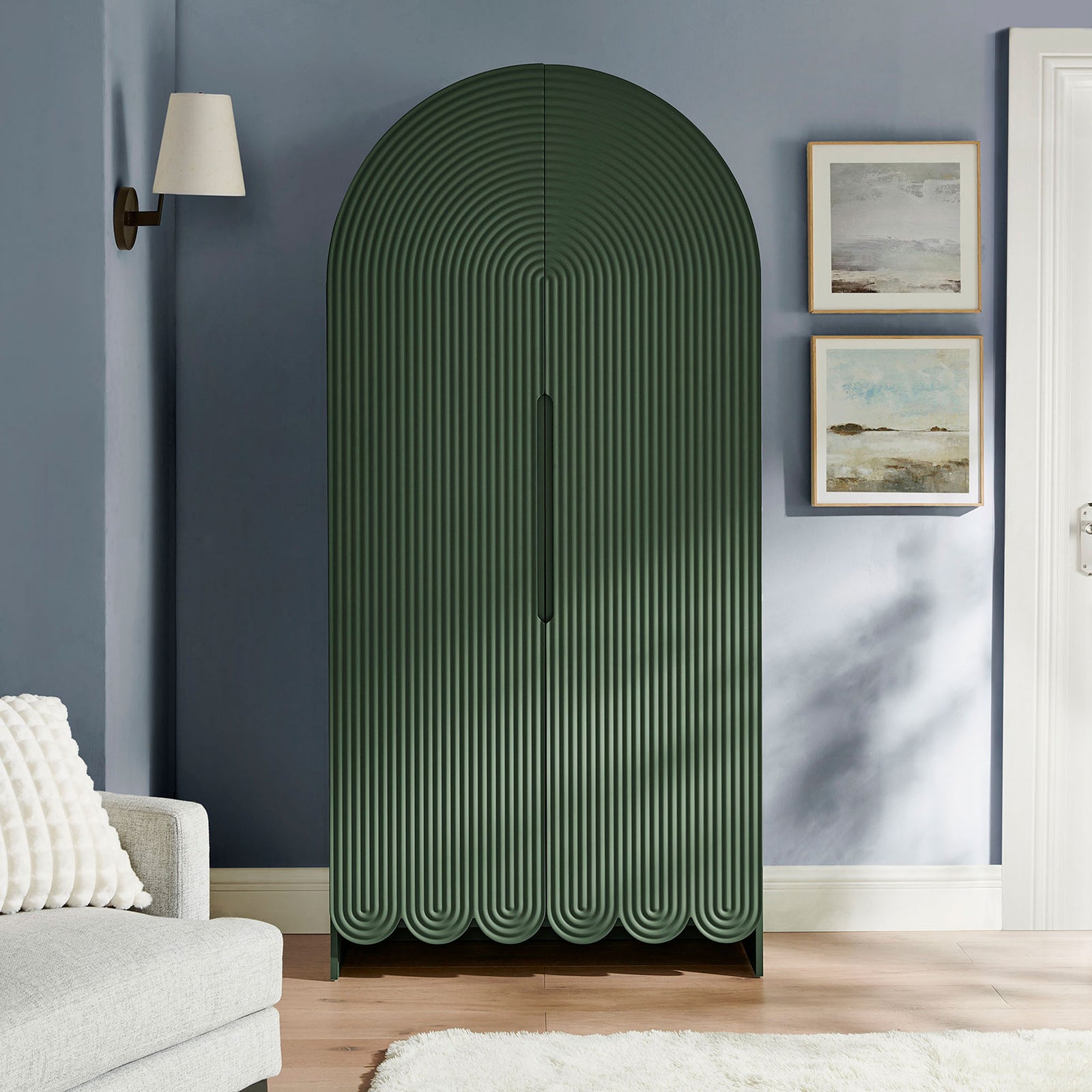 Hunter green arched storage cabinet adding sculptural fluted texture to a modern living room || EEI-7570-HGR || front_room