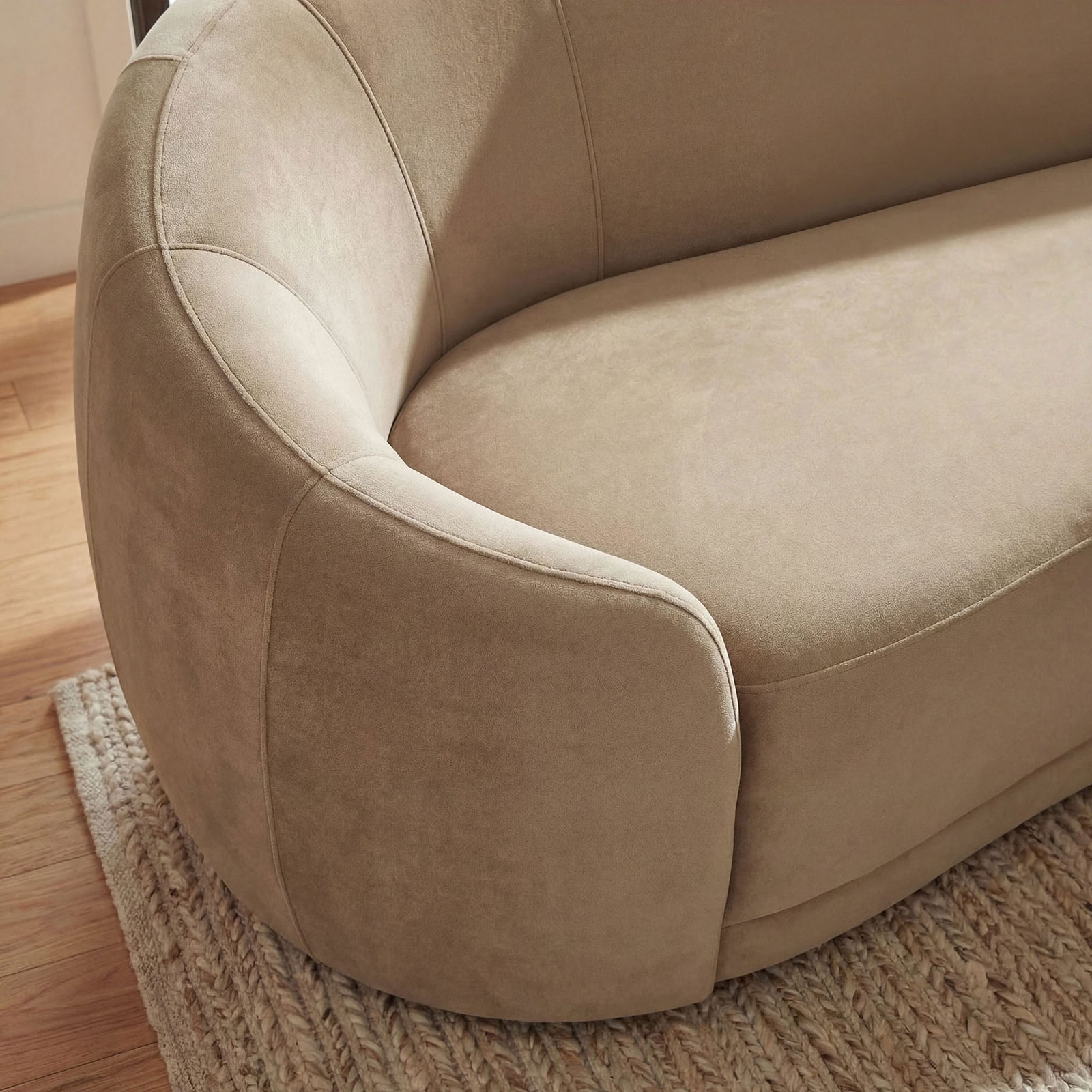 The sofa arm in a cozy room shows the soft taupe sheen and fine velvet texture. || EEI-7581-TAU || detail_room